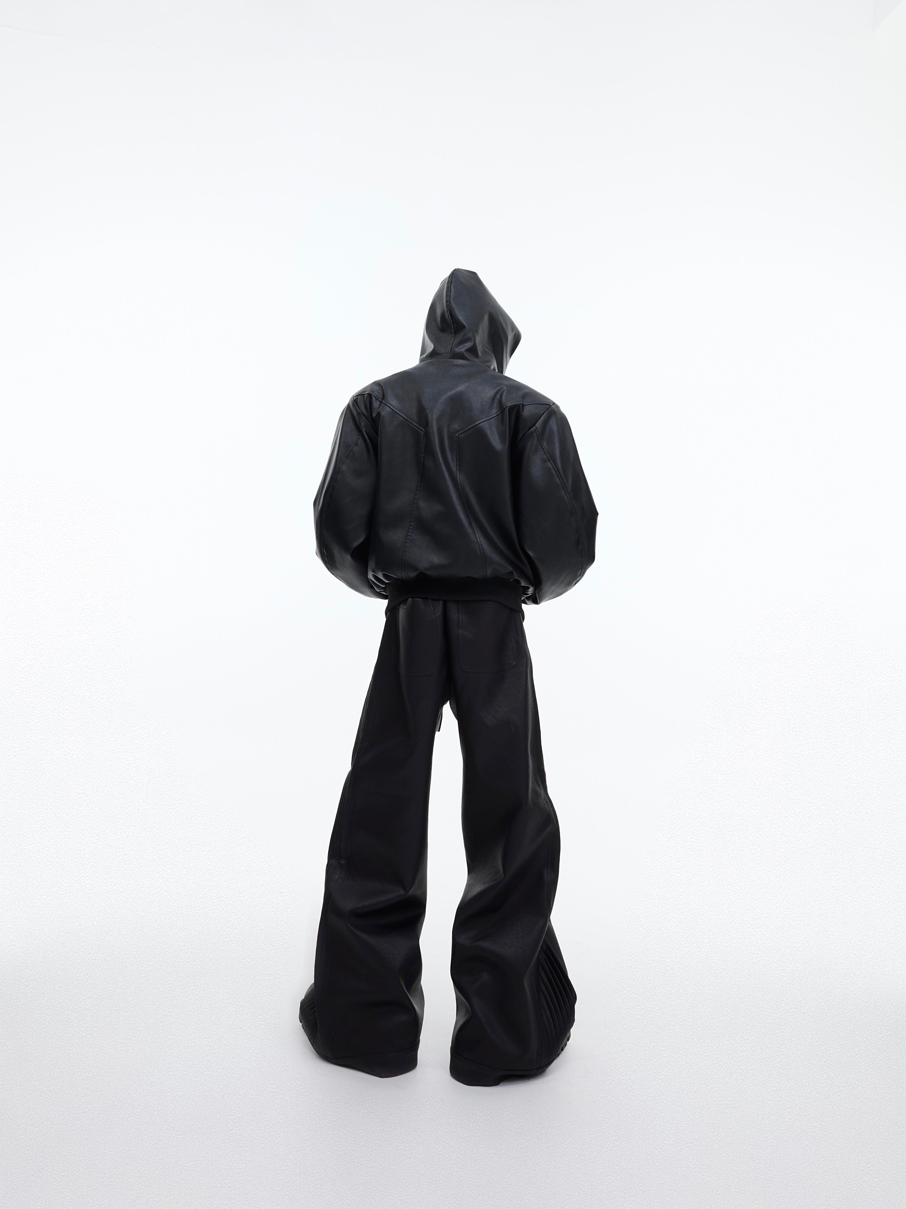 Back view of deconstructed leather trousers highlighting the straight-leg silhouette