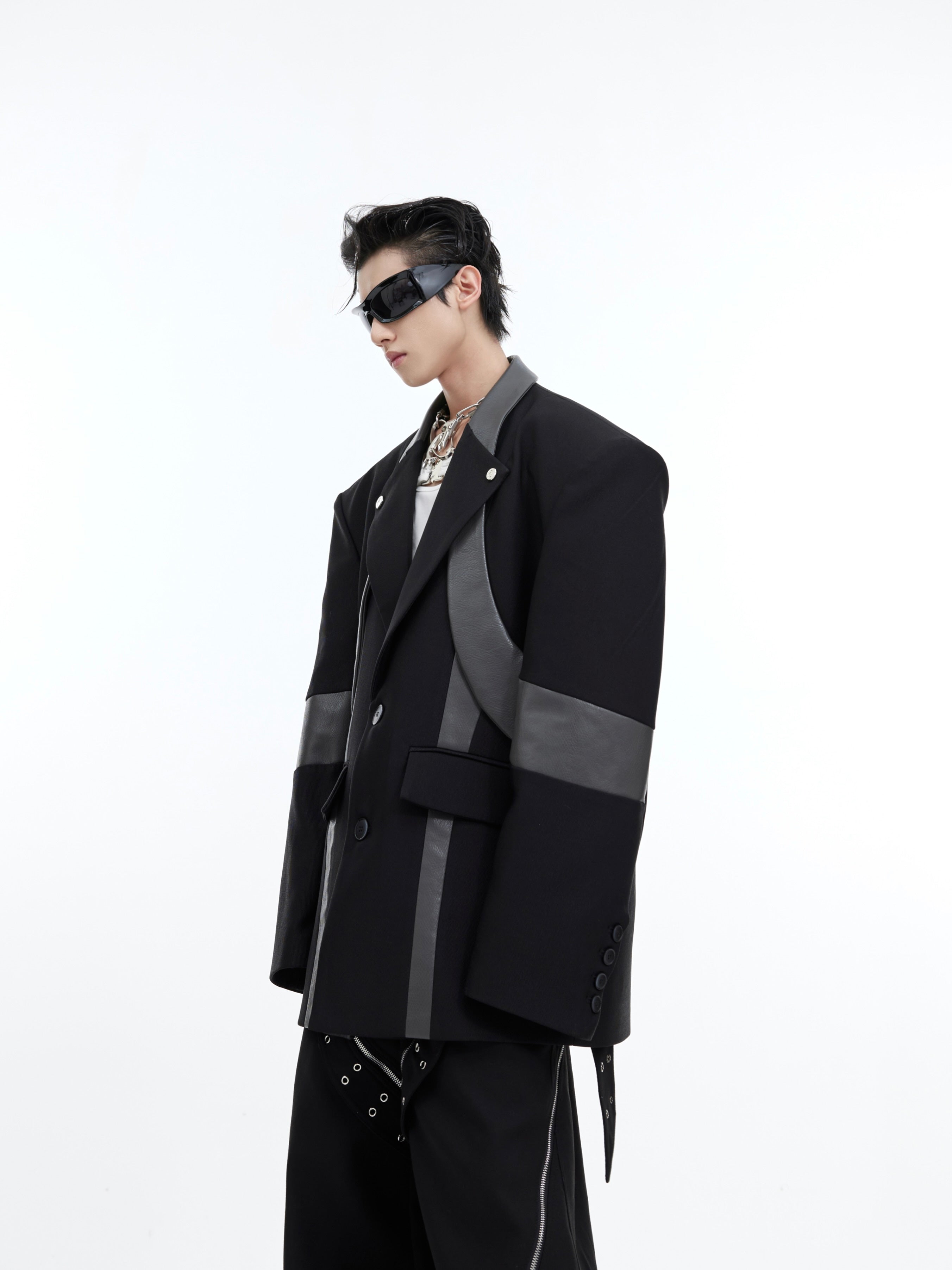 Back view showing unique asymmetrical panels and patchwork construction of edgy blazer
