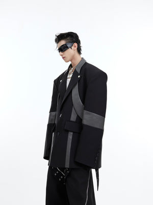 Back view showing unique asymmetrical panels and patchwork construction of edgy blazer