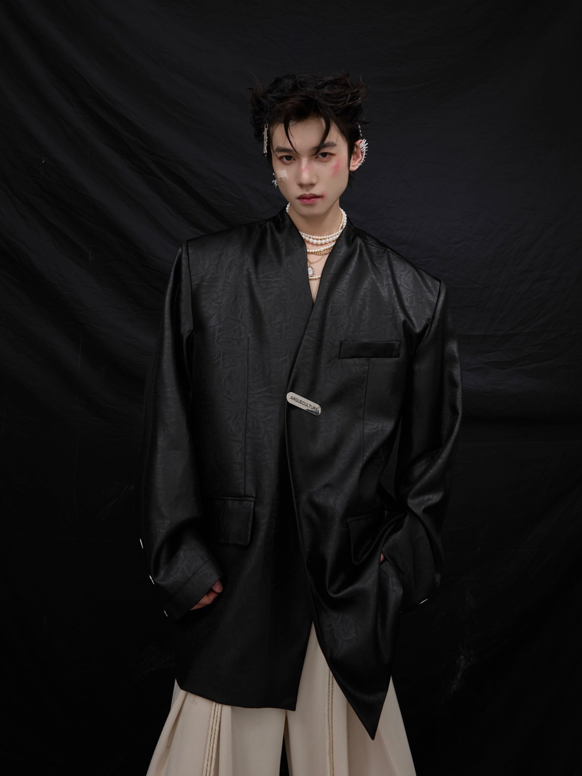 Back view of oversized blazer with striking liquid metal texture and bold silhouette for urban street style