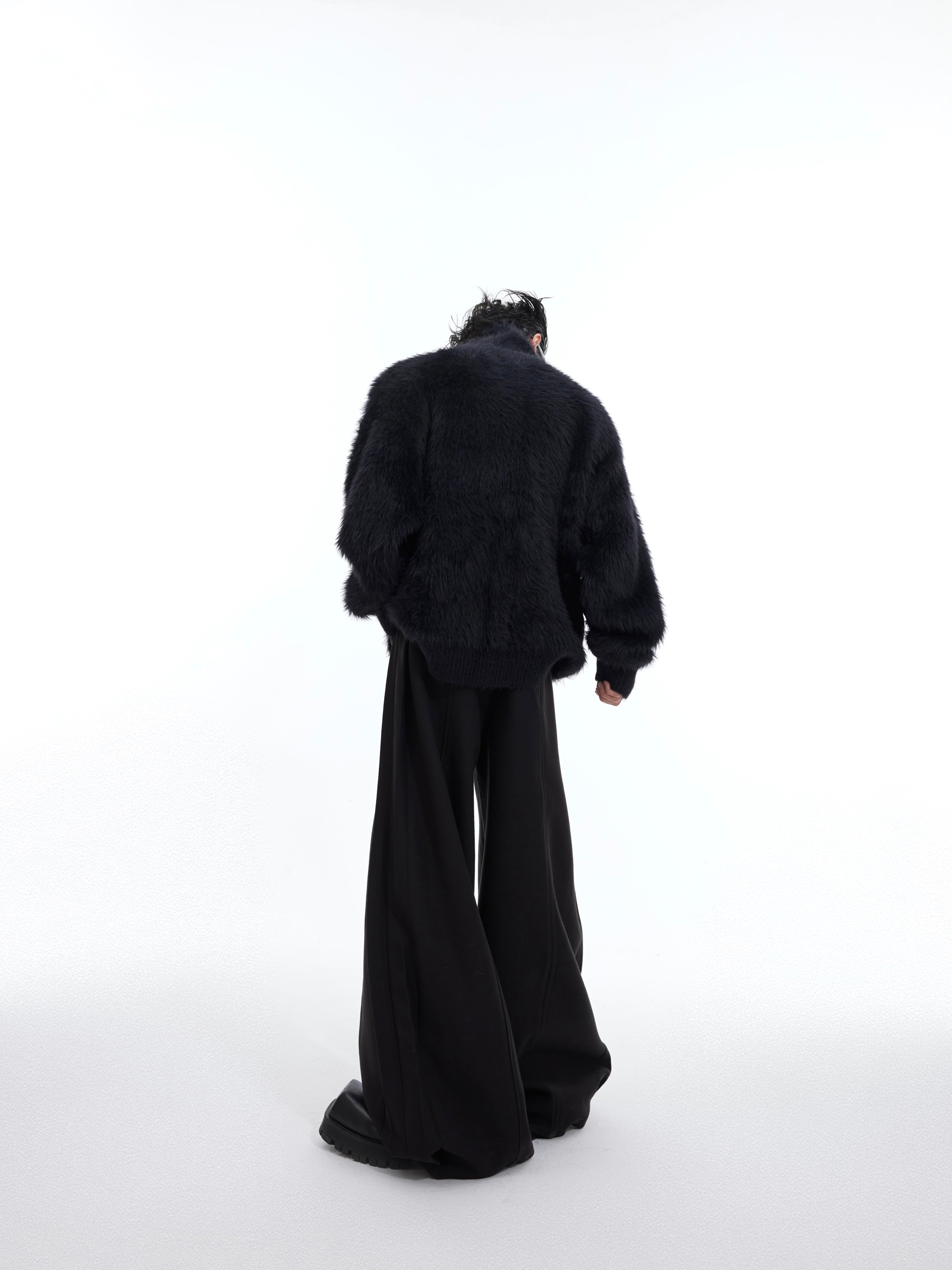 Back view of deconstructed patchwork cardigan showing urban fashion design elements