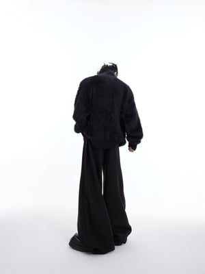 Back view of deconstructed patchwork cardigan showing urban fashion design elements