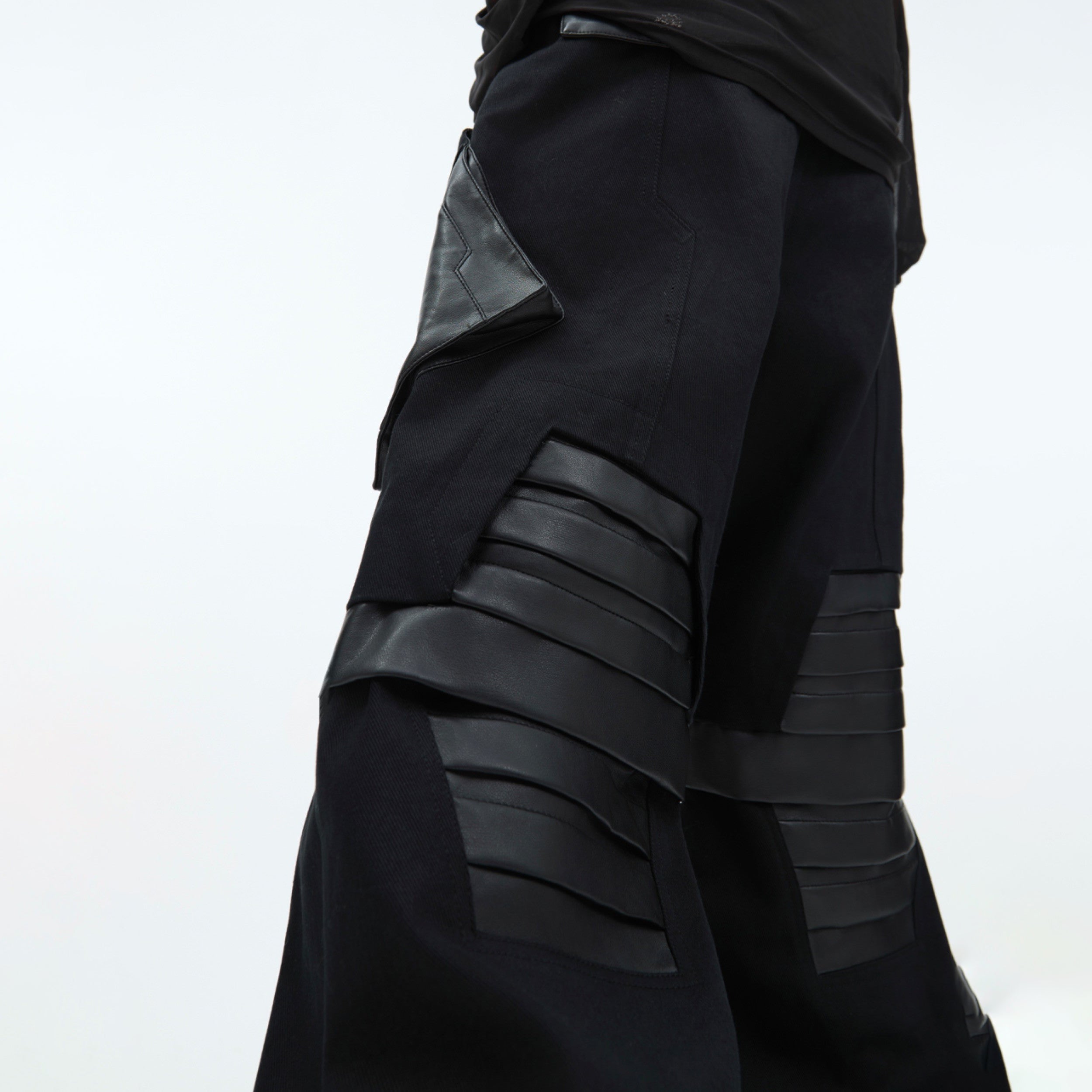 Detailed view of adjustable waistband and belt loops on these urban-style deconstructed pants
