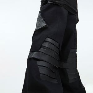 Detailed view of adjustable waistband and belt loops on these urban-style deconstructed pants