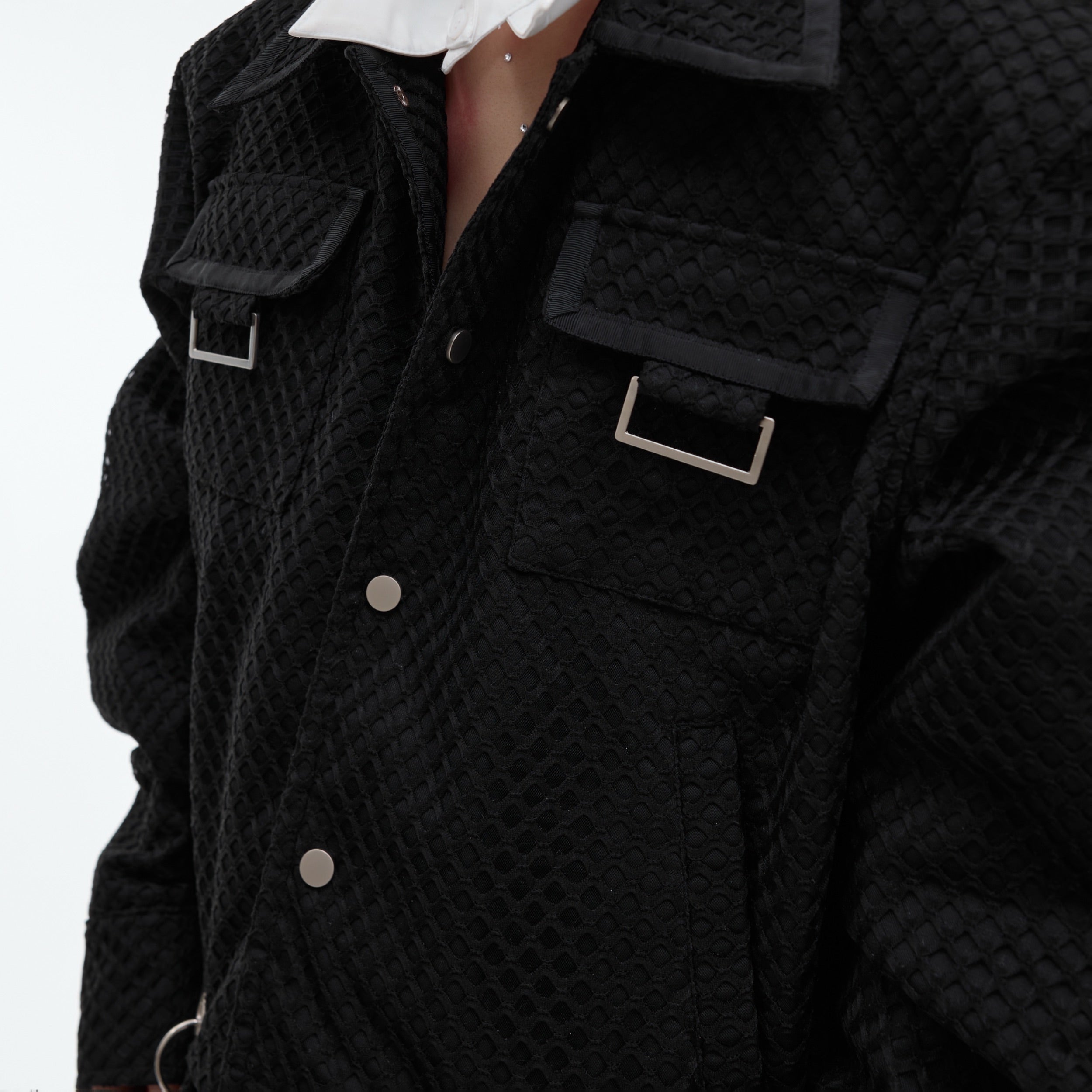 Close-up of geometric layering and dimensional details on this unique textured streetwear coat