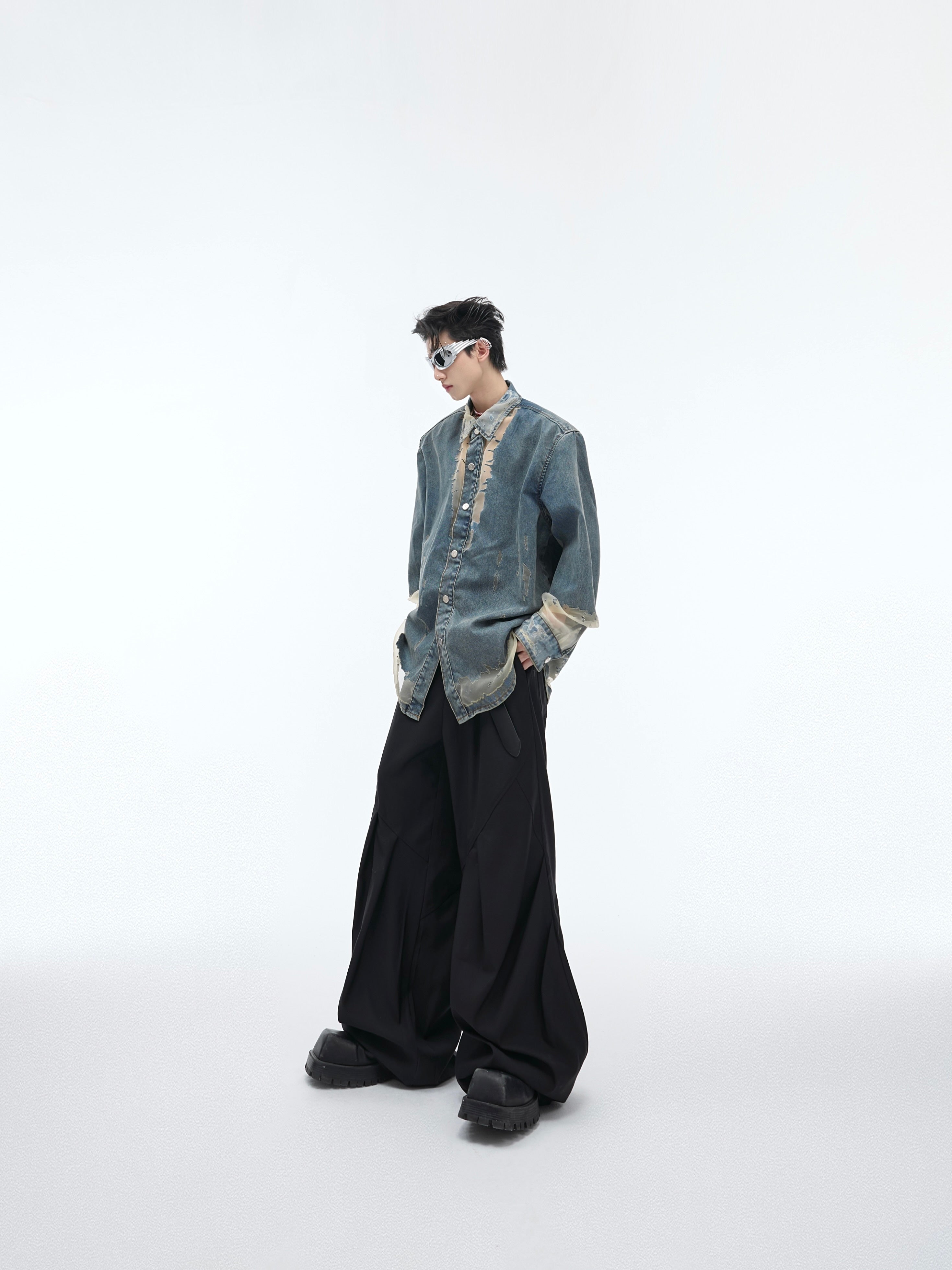 Styling example of deconstructed denim shirt layered over basic tee, showcasing urban fashion versatility