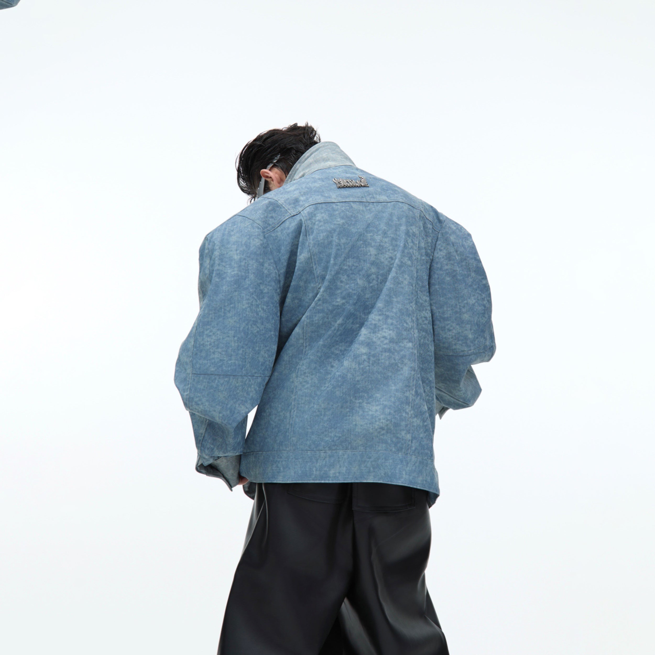 Stylish model wearing the PU leather overshirt jacket with asymmetrical cut and urban fashion appeal