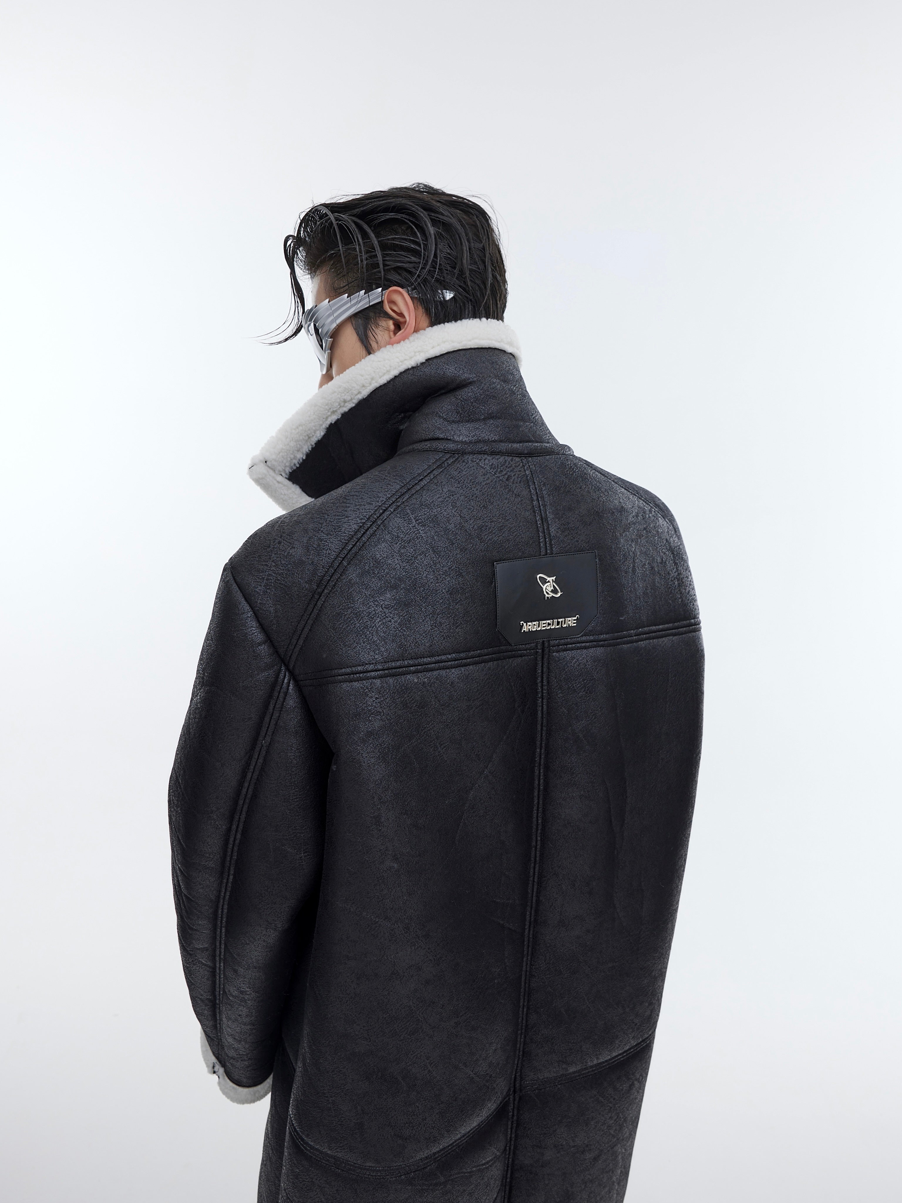 Model wearing deconstructed shearling coat from the front, highlighting the statement-making oversized silhouette