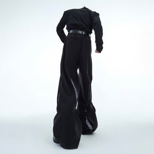 Back view of high-fashion deconstructed pants with minimalist tailoring for urban looks