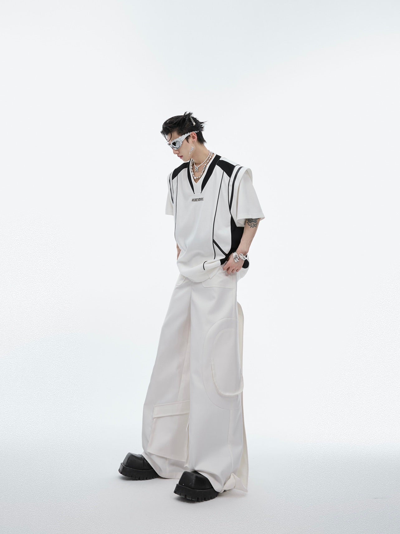 Stylish outfit featuring these deconstructed ribbon-tie trousers paired with urban fashion accessories