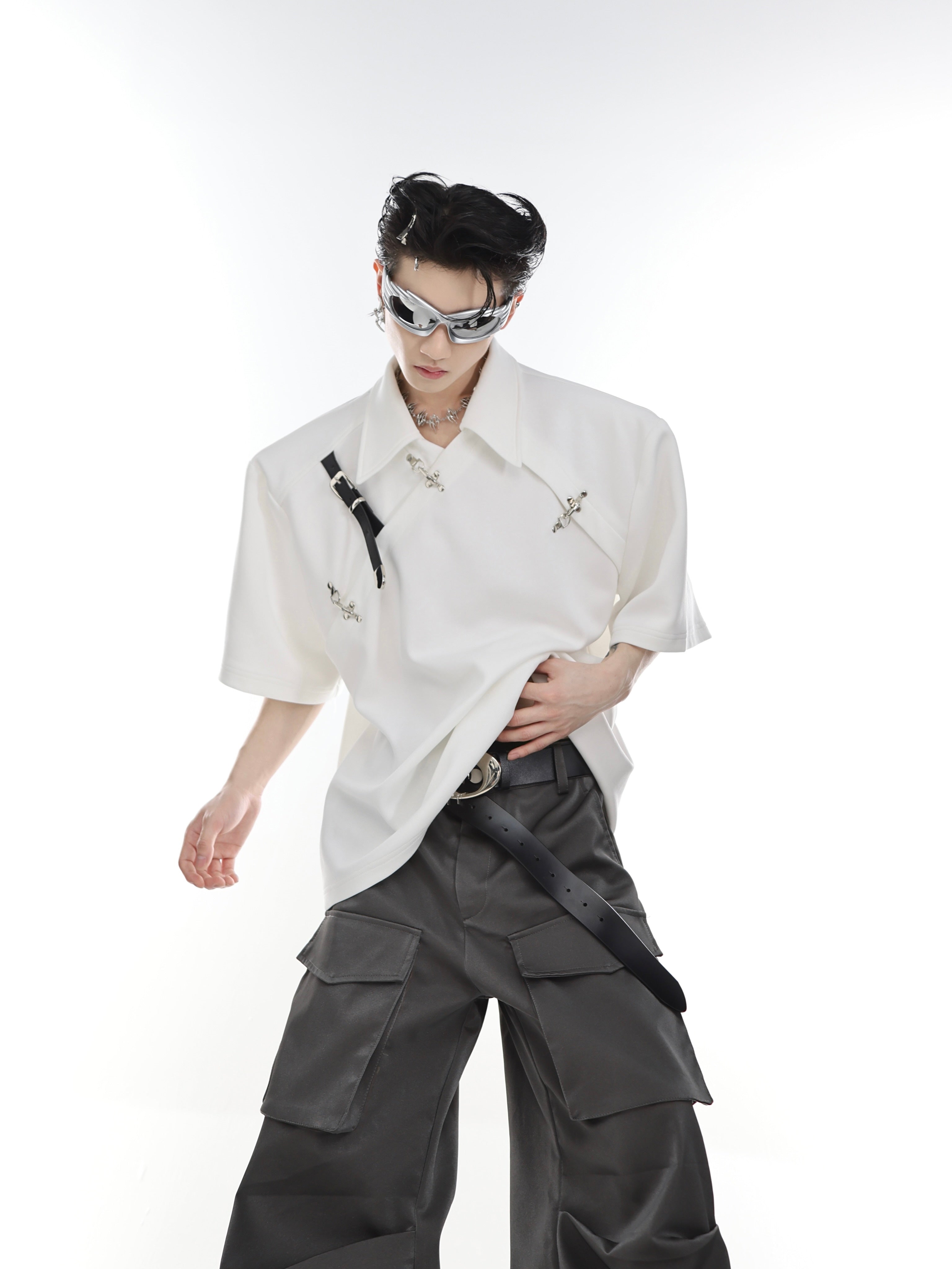 Male model wearing deconstructed polo shirt with metal buckle, showing full front design