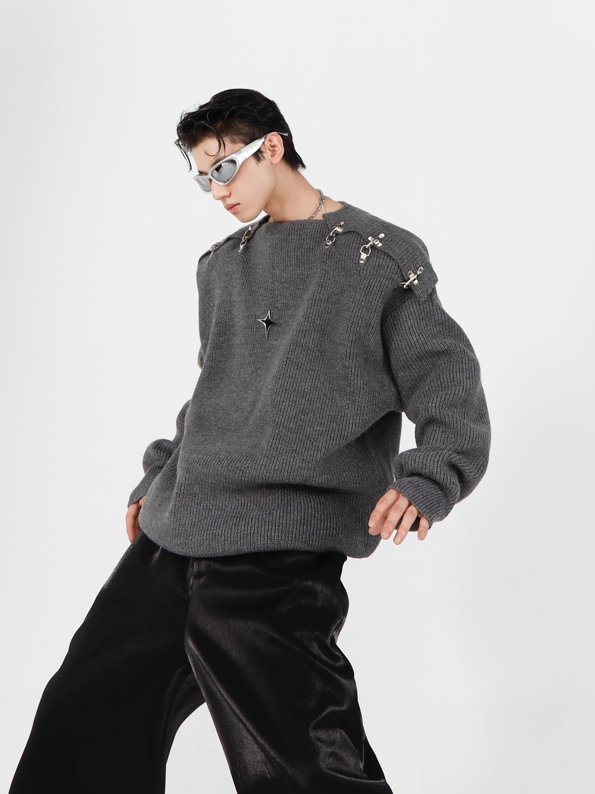 Side view of avant-garde streetwear sweater showing signature metal buckle design elements
