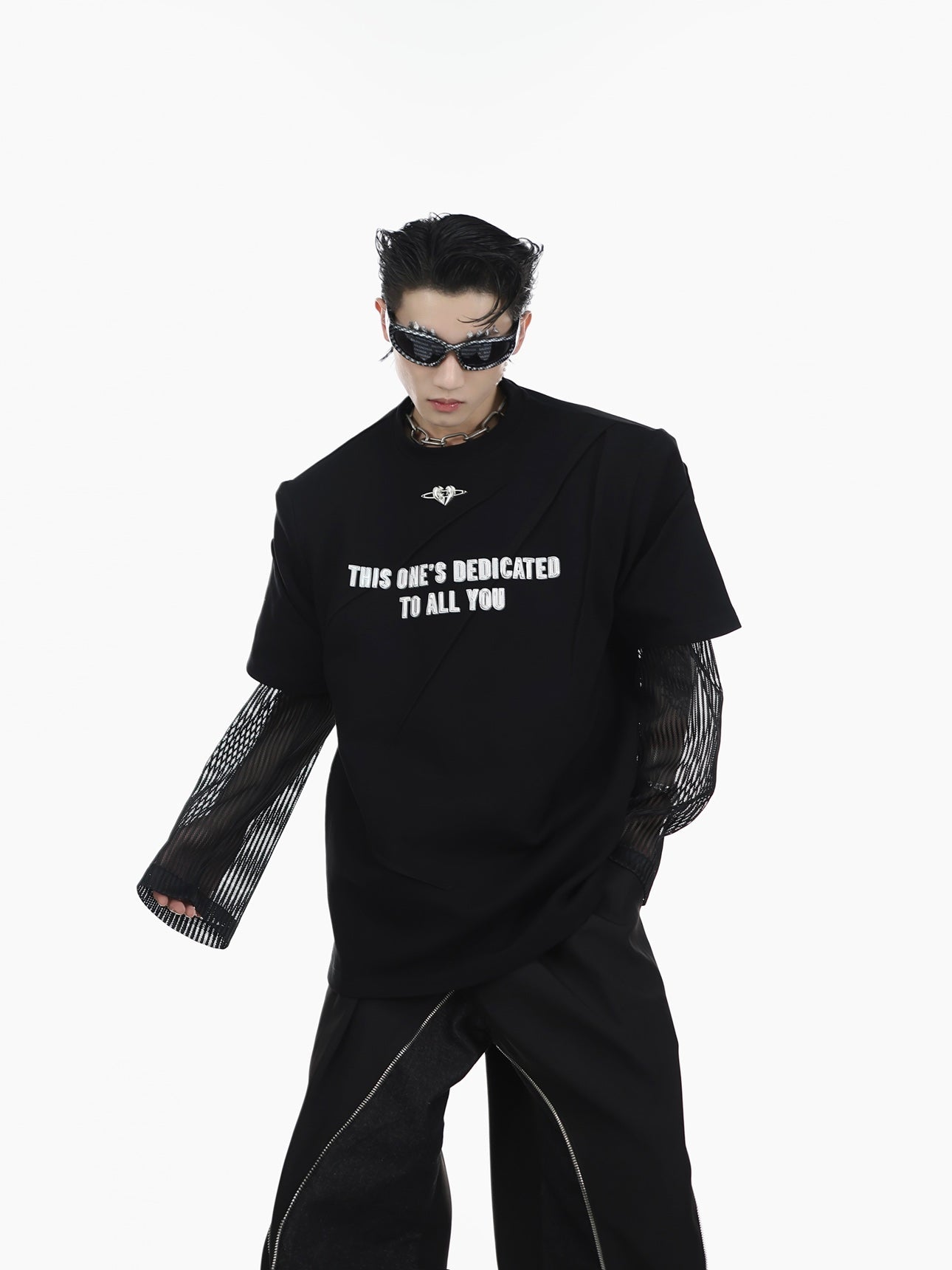 Layflat view of the oversized graphic tee showing the complete distressed metal letter print design and fabric texture