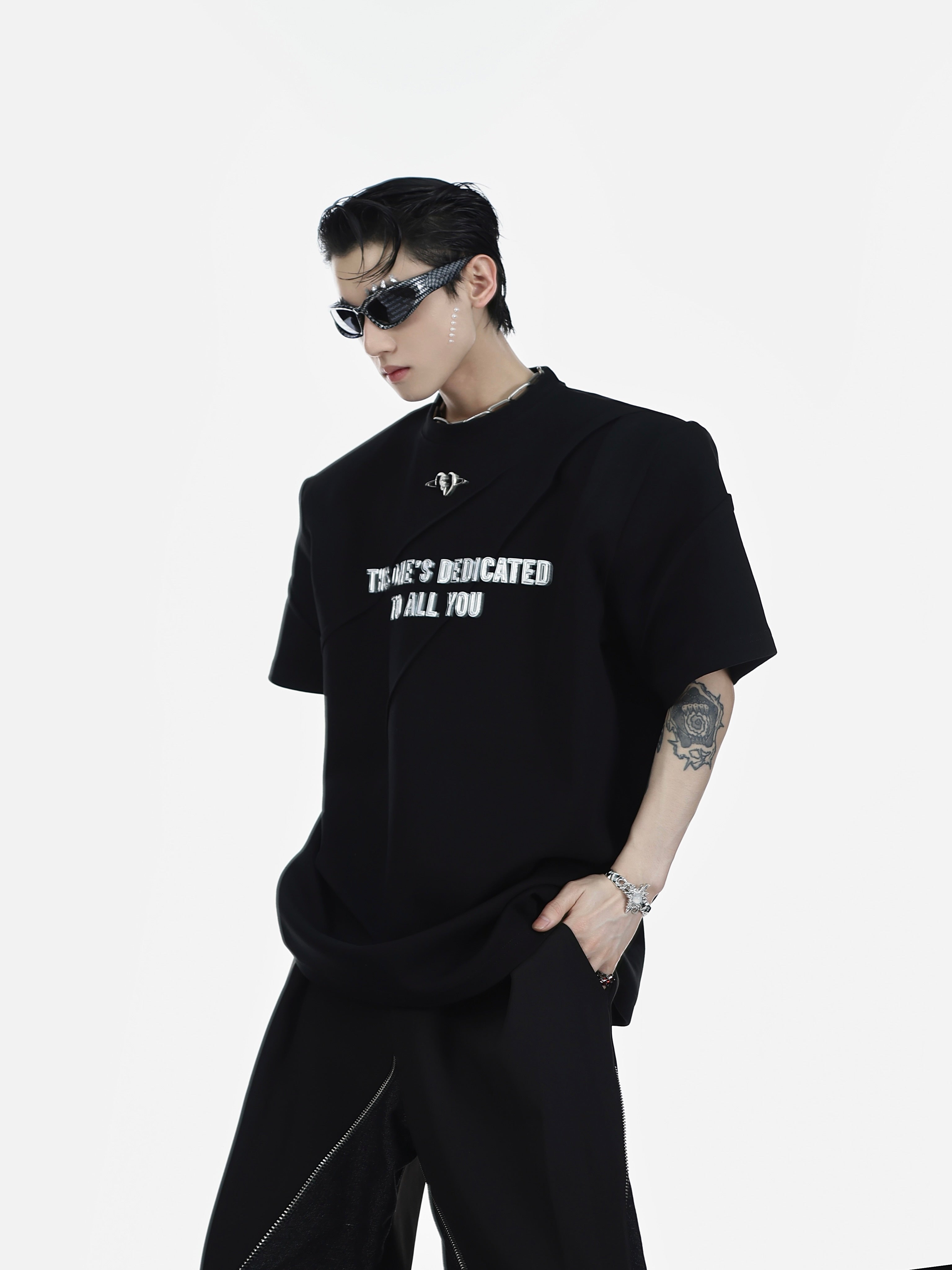 Side angle showing the relaxed fit of this premium cotton graphic tee with distressed print details and dropped shoulders
