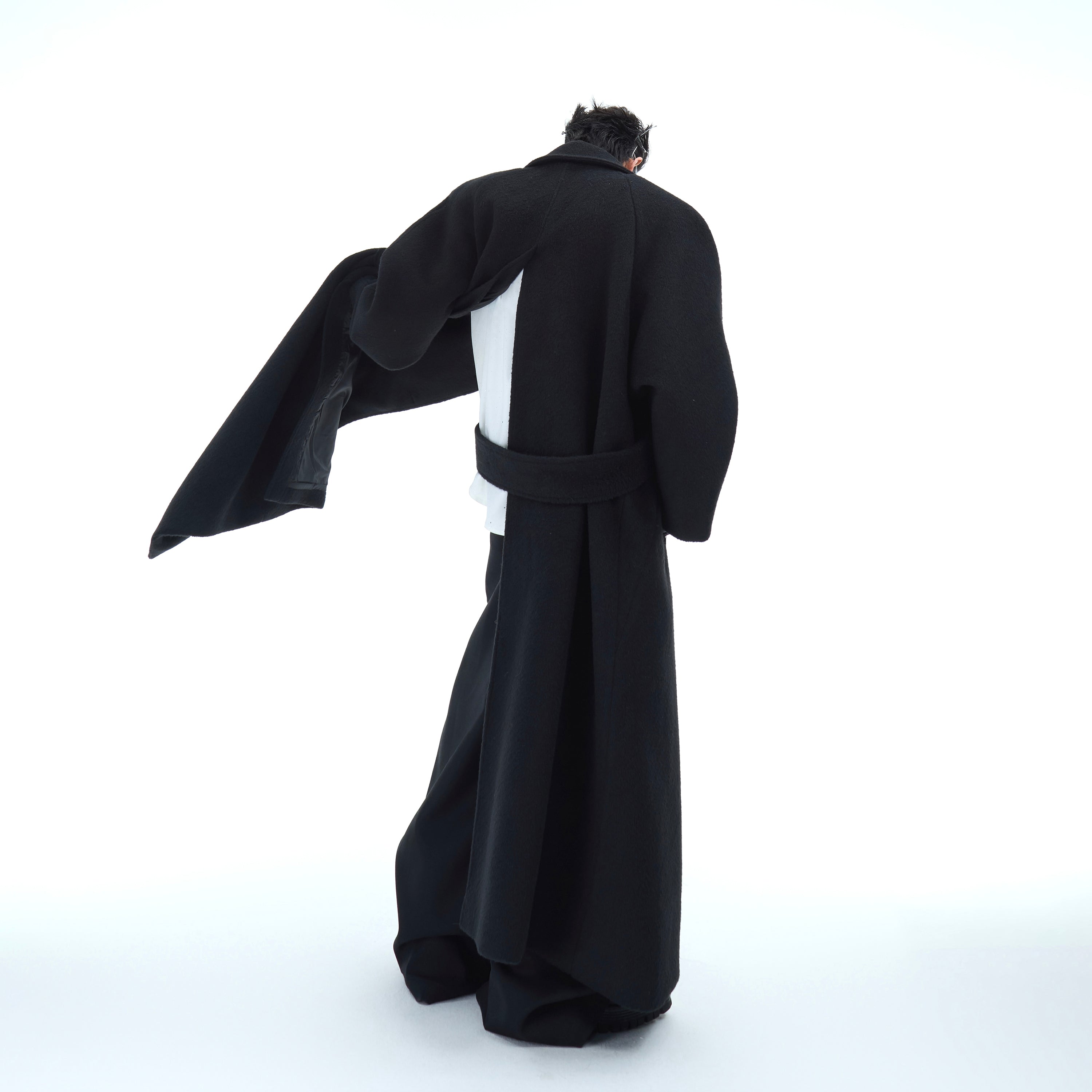 Back view of stylish streetwear wool overcoat with oversized fit and smooth texture