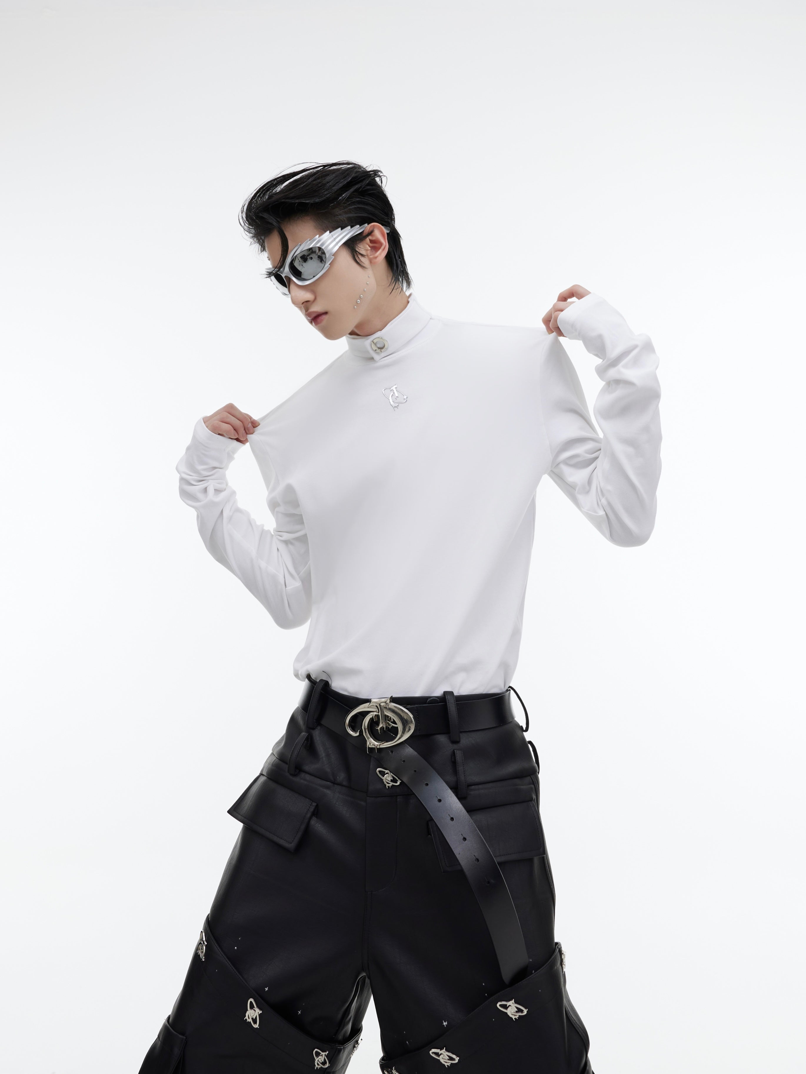 Close-up of signature shoulder pads on high-neck shirt showing the structured silhouette enhancement