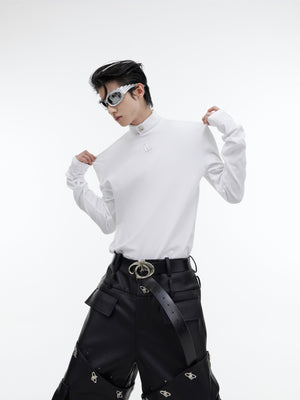 Close-up of signature shoulder pads on high-neck shirt showing the structured silhouette enhancement