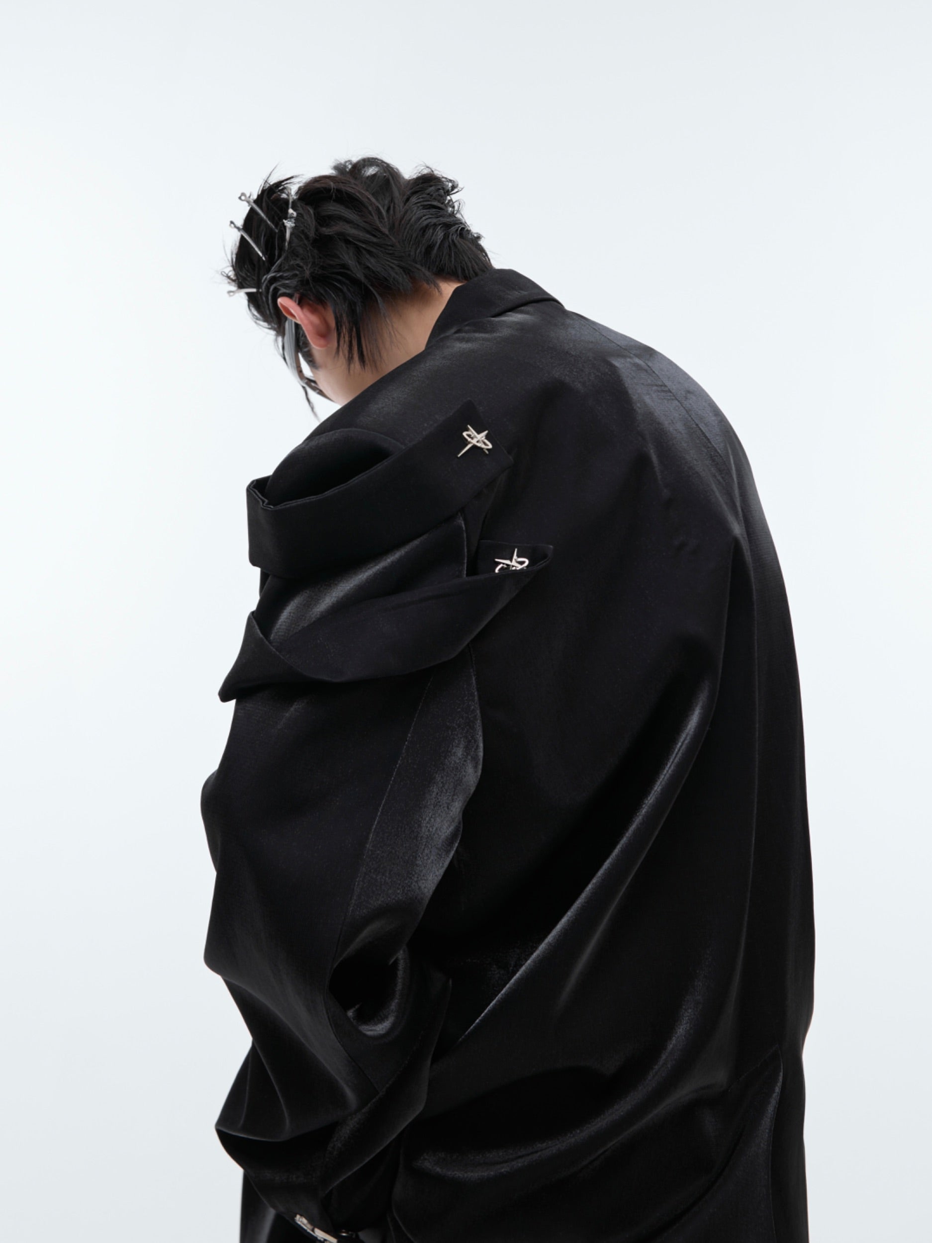 Back view of liquid-shine blazer highlighting the structured shoulders and split detailing