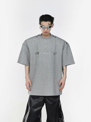 Close-up of industrial-style metal airplane buckle on edgy streetwear t-shirt with deconstructed design