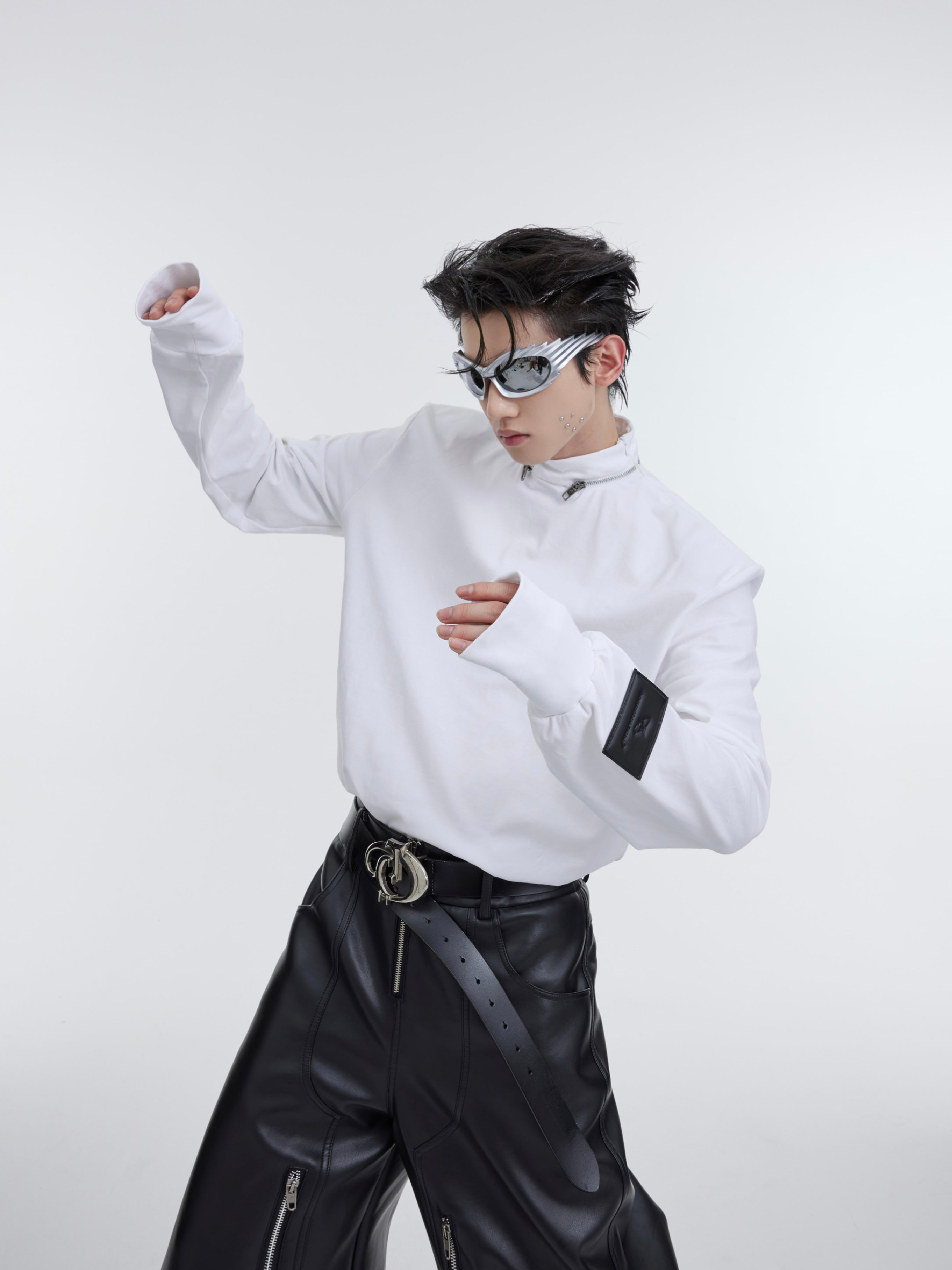 Side angle showing the structured slim-fit tee with distinctive contrast cuff detailing and statement collar