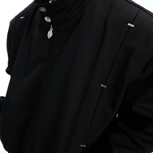 Side profile of studded collar Harrington jacket showing architectural silhouette and premium fabric