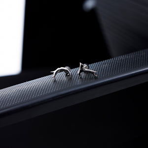 Detailed shot of premium quality T-shaped earrings highlighting the intricate deconstructed metal work