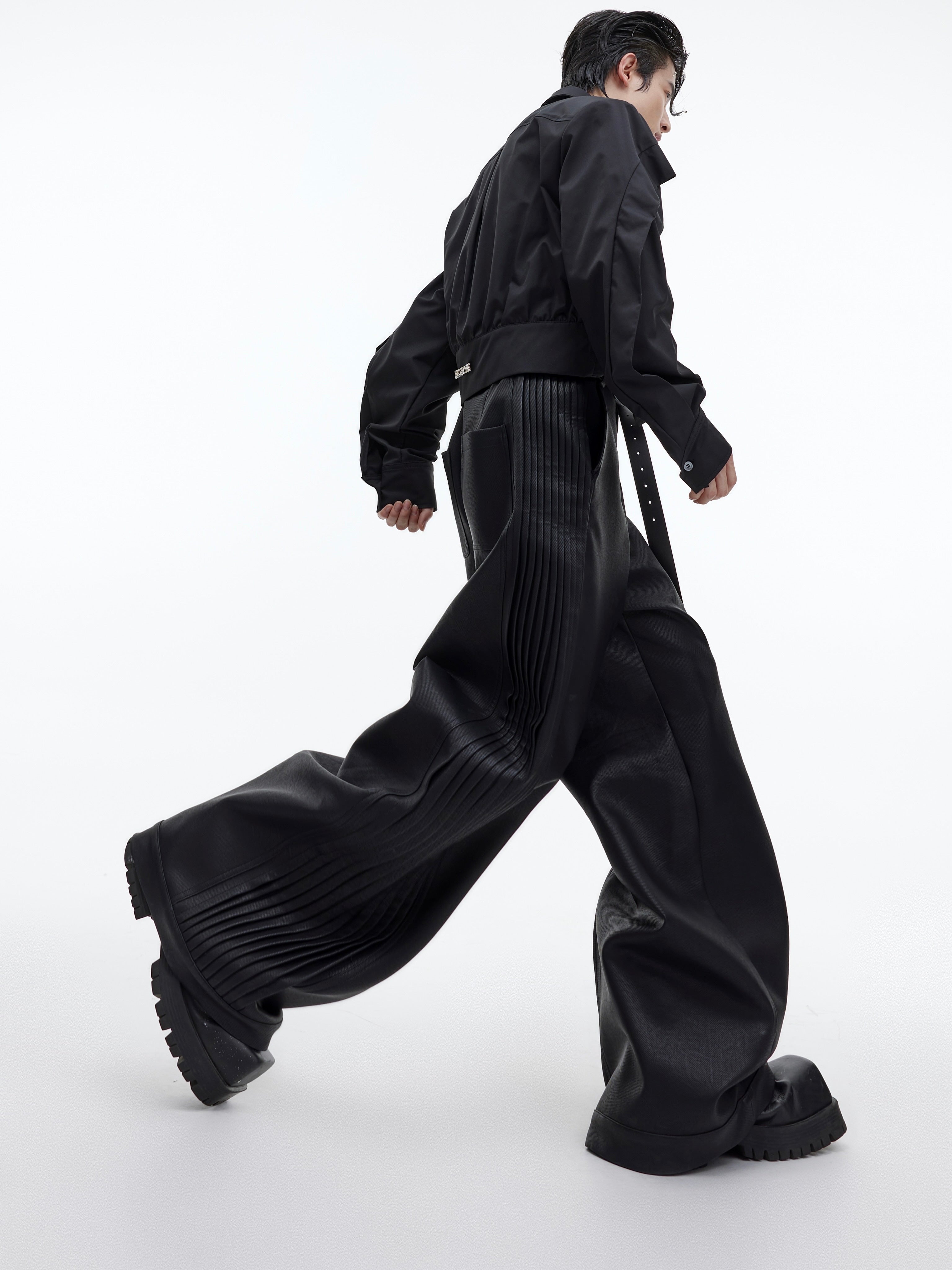 Model wearing loose straight-leg leather pants showing the relaxed fit and urban streetwear style