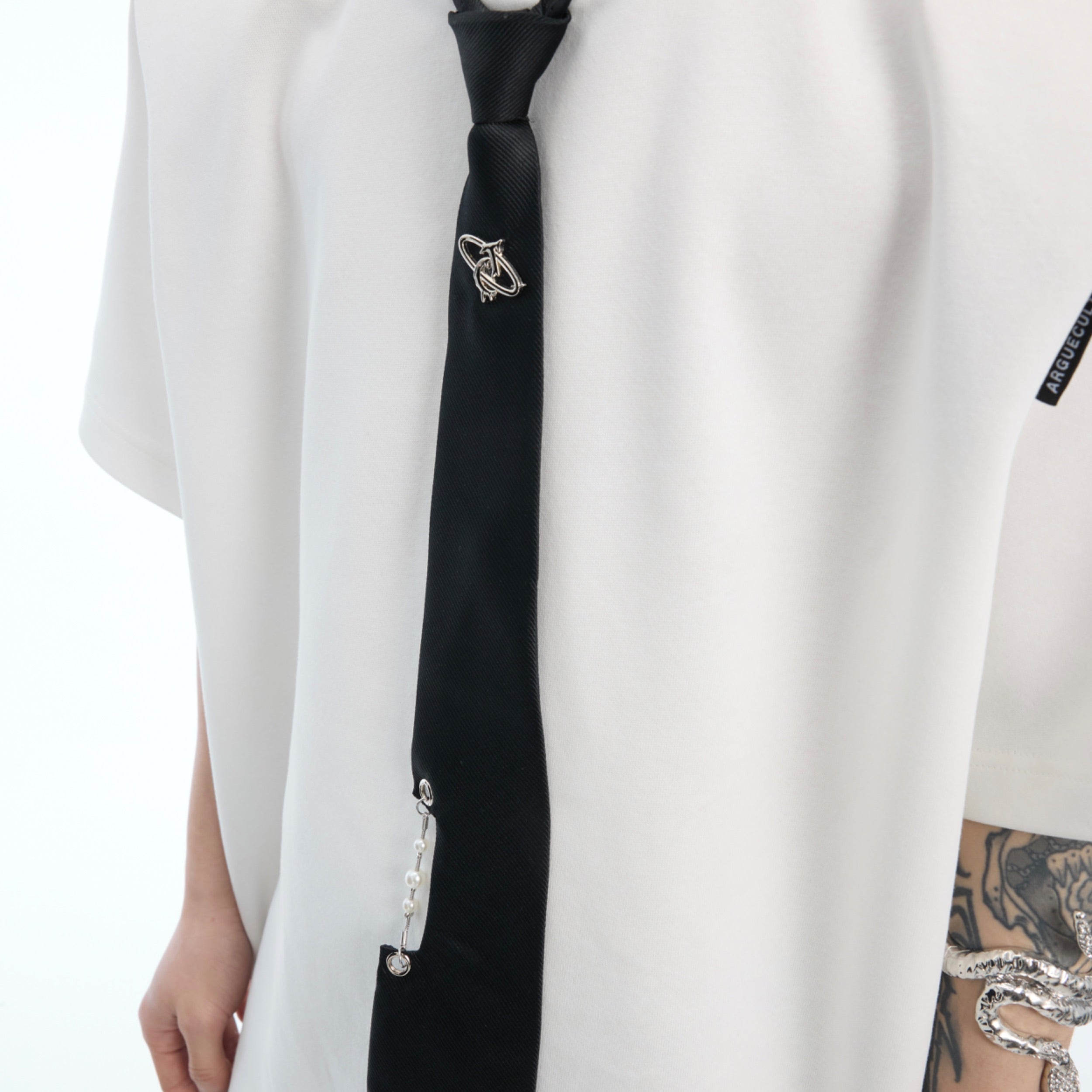 Close-up of the stylish necktie detail on this unique patchwork tie-dye oversized streetwear top