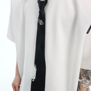 Close-up of the stylish necktie detail on this unique patchwork tie-dye oversized streetwear top