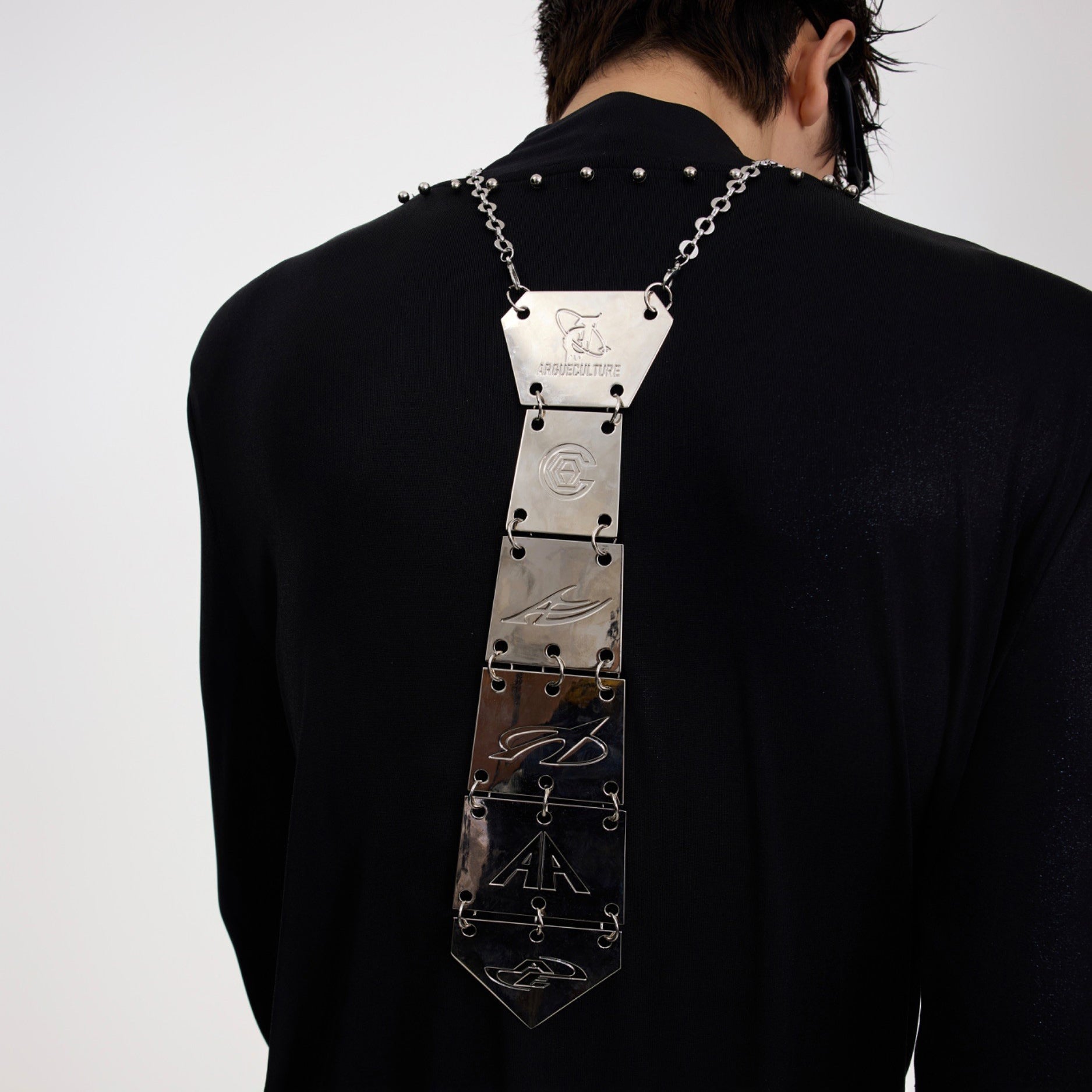 Close-up of durable clasp mechanism on the retro metal tie necklace for secure wearing and adjustable fit