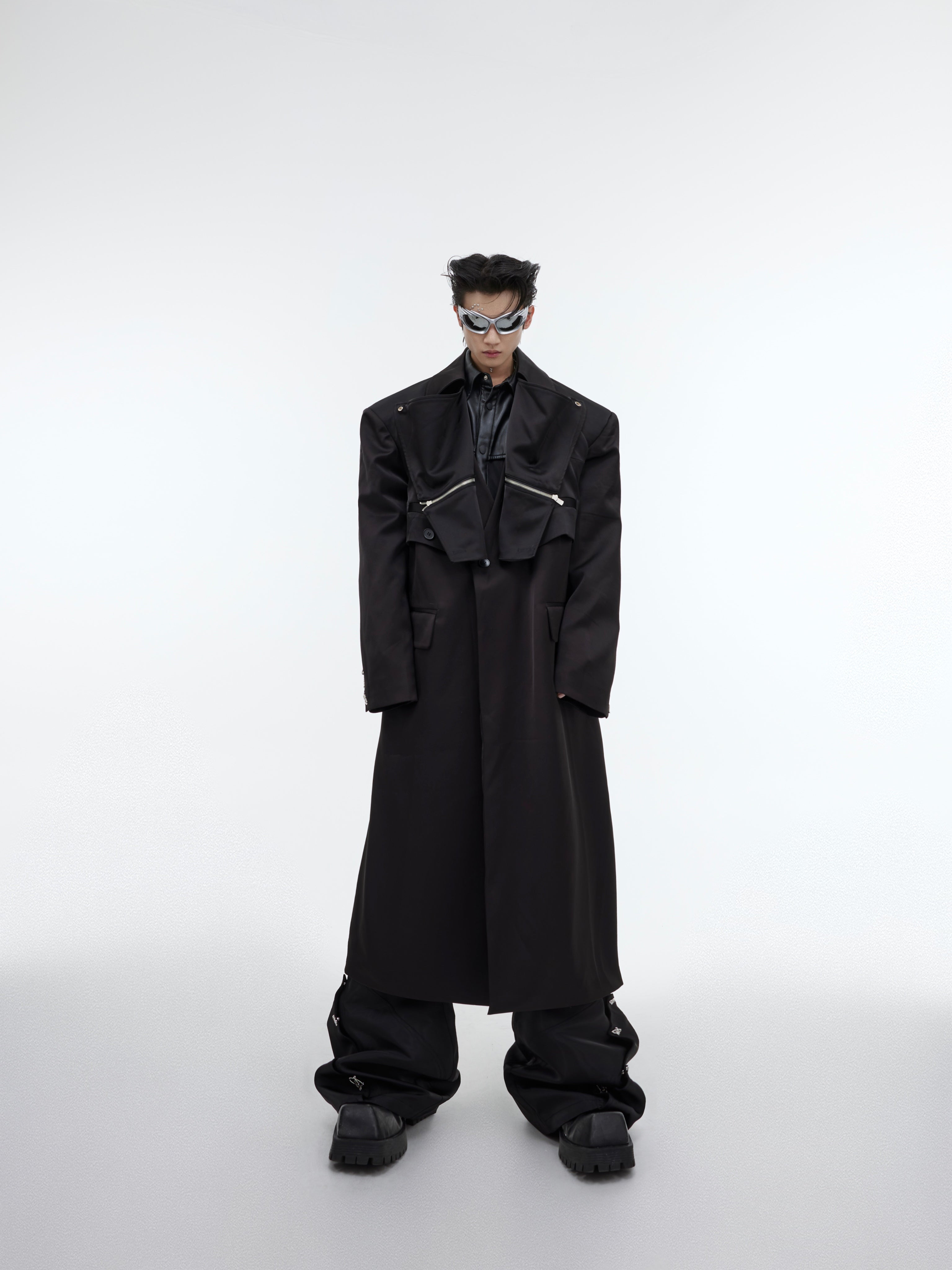 Close-up of the innovative layering details on this fashion-forward deconstructed long trench coat