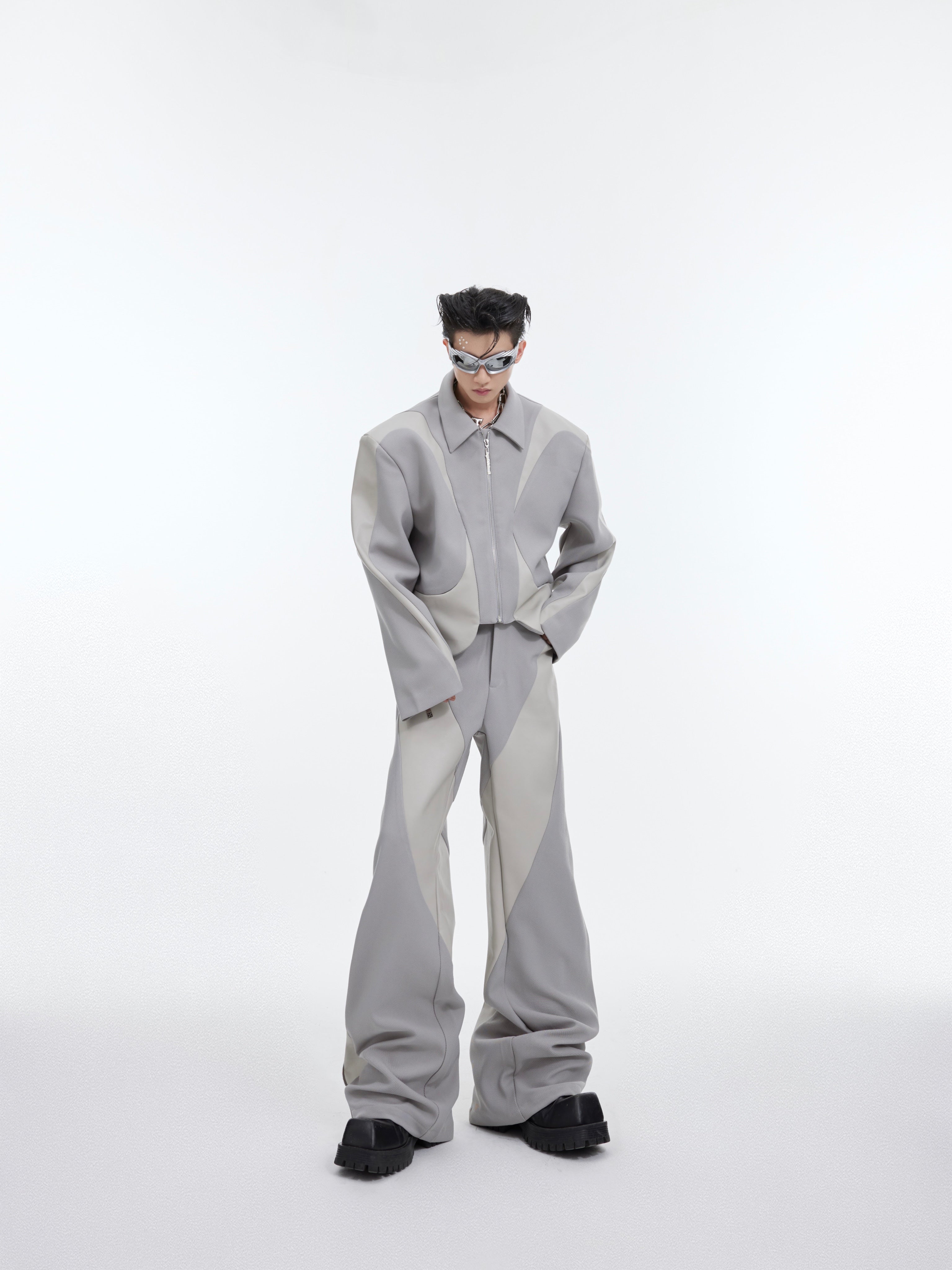 Side angle of twill blend leather trim suit showcasing the deconstructed shoulder pads and premium fabric texture