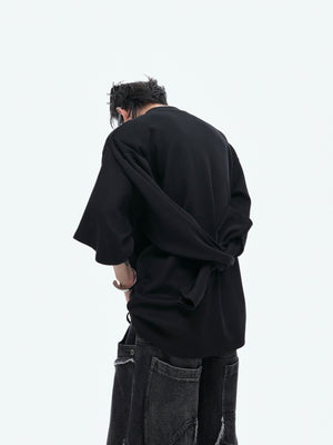 Back view of model wearing edgy reconstructed hoodie with urban oversized silhouette for street style