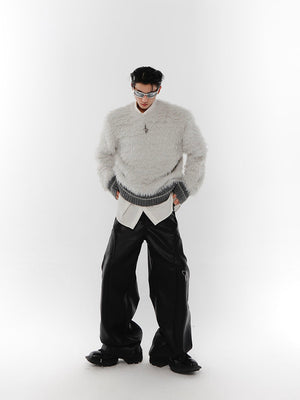 Slim-fit model wearing unisex chunky knit streetwear sweater with metal accents