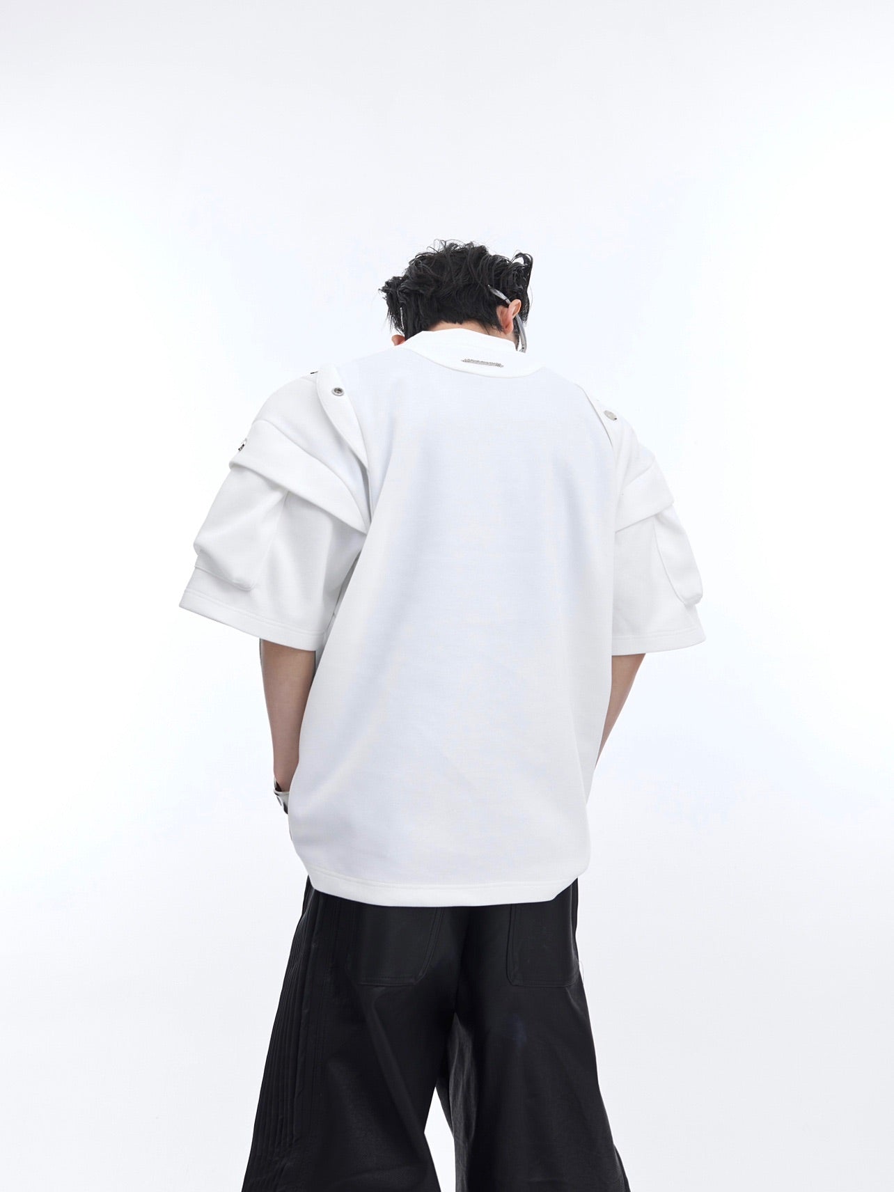 Raw edge details on this oversized deconstructed t-shirt create a modern streetwear aesthetic