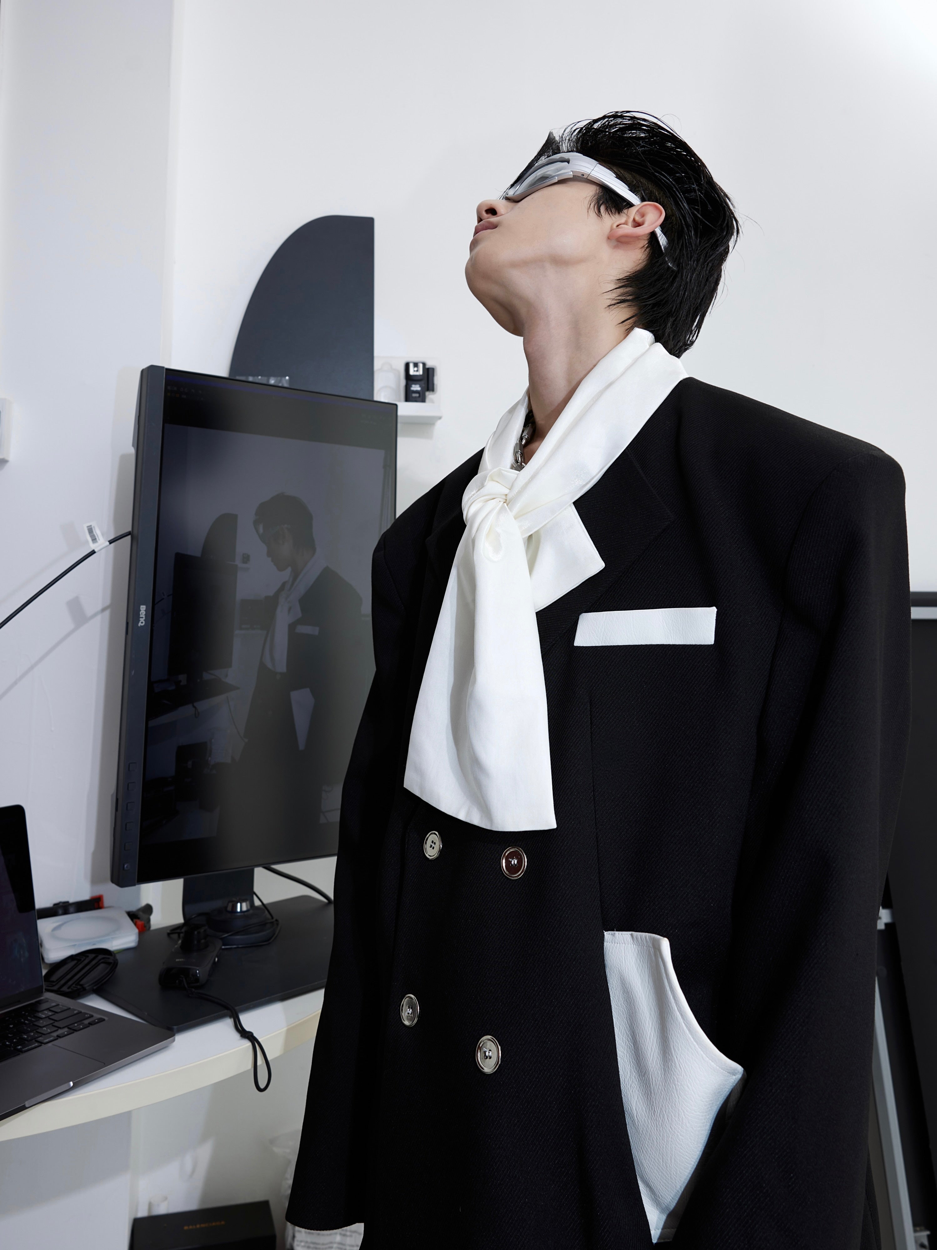 Side angle of contemporary blazer highlighting the signature tie-collar and tailored silhouette