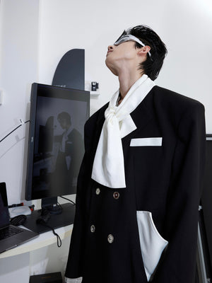 Side angle of contemporary blazer highlighting the signature tie-collar and tailored silhouette