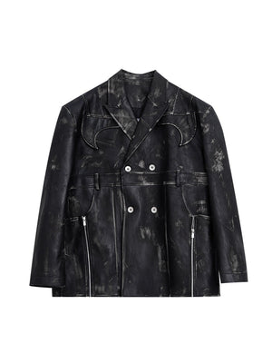 Close-up of the deep V-neck cut and raw edge detailing on this avant-garde leather blazer