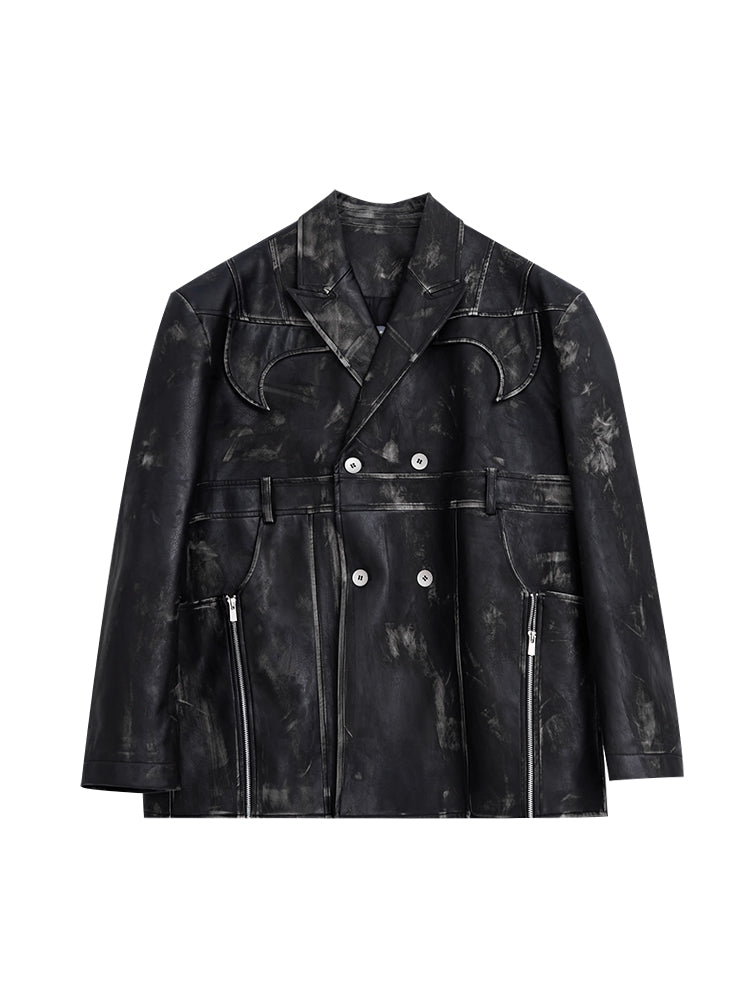 Close-up of the deep V-neck cut and raw edge detailing on this avant-garde leather blazer