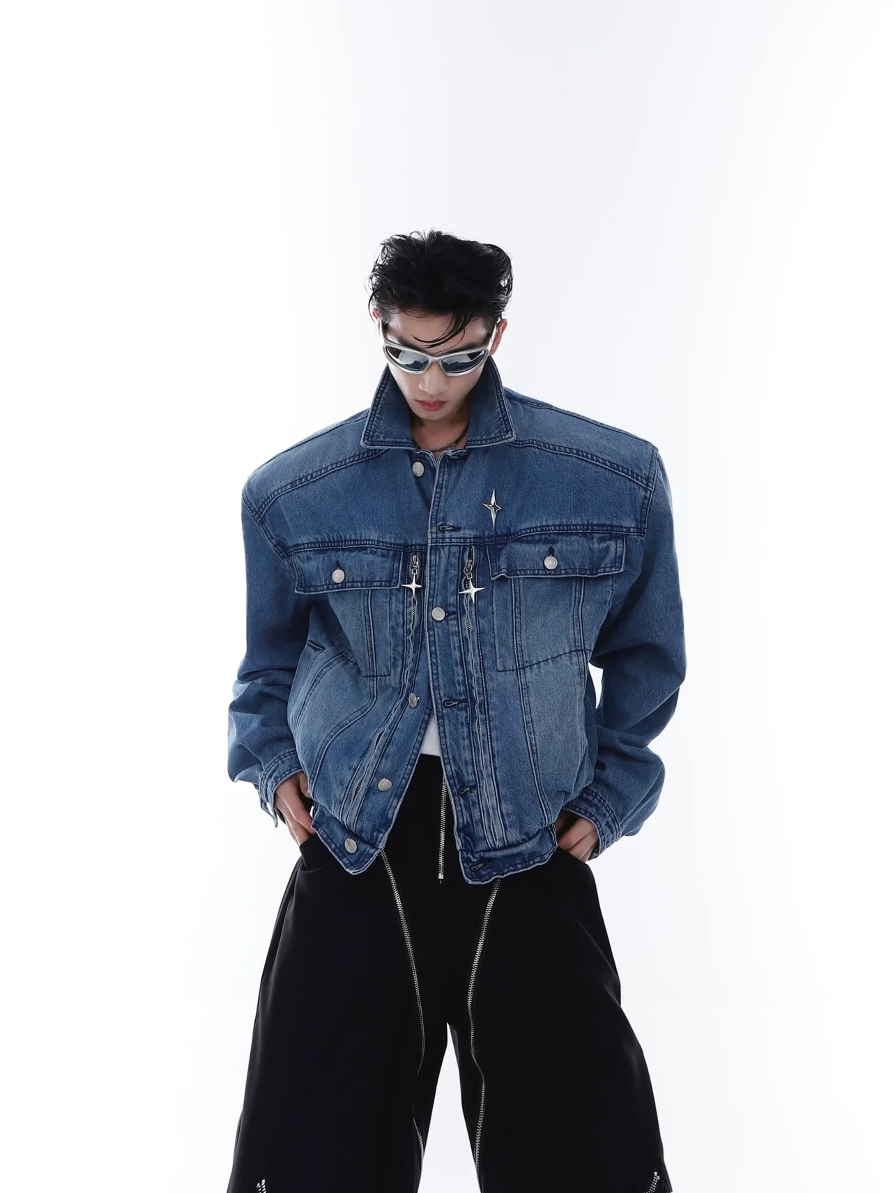 Vintage washed denim jacket with cropped oversized fit and metal zipper, showcasing avant-garde streetwear style