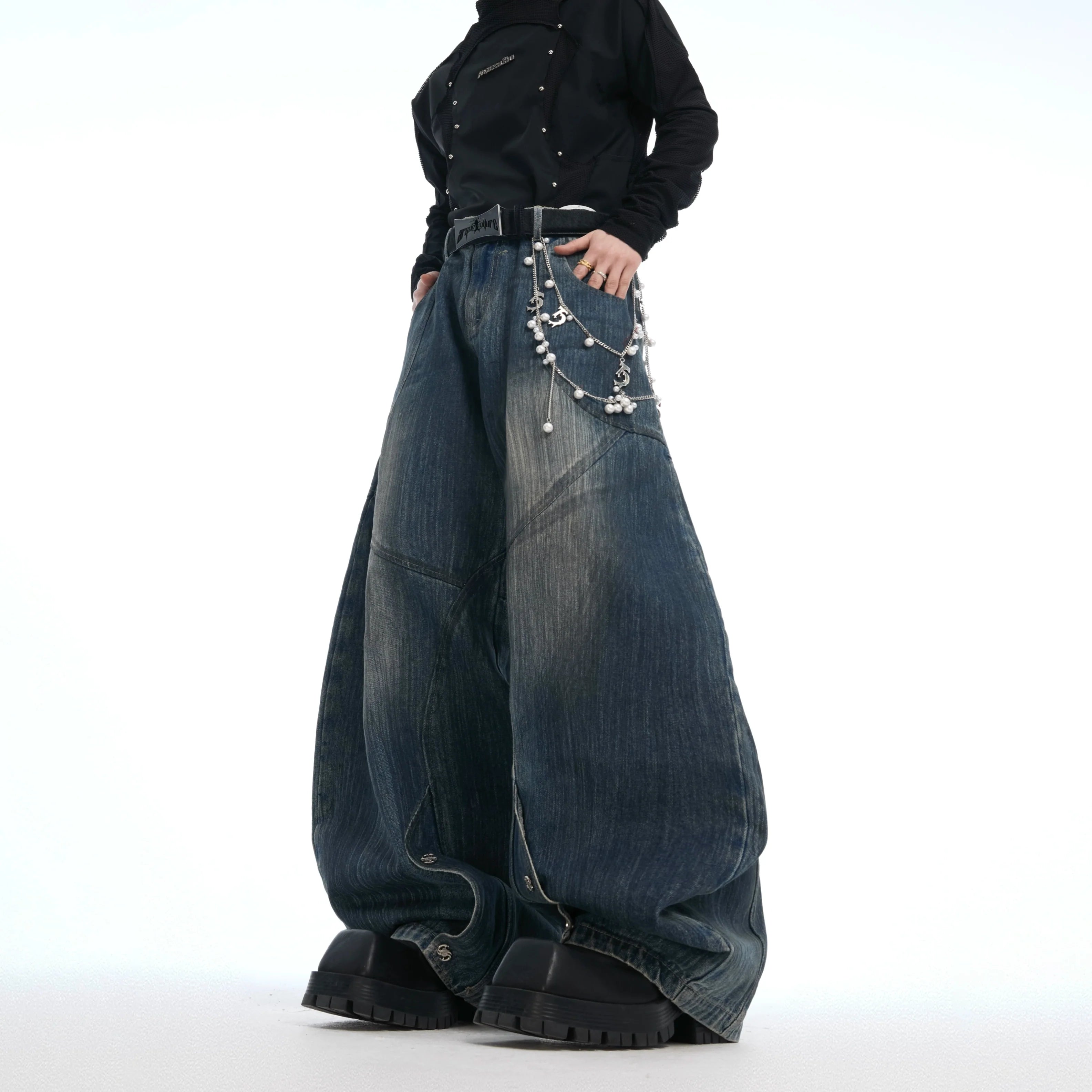 Vintage distressed jeans with pearl accents showcasing loose wide leg fit and unique deconstructed details