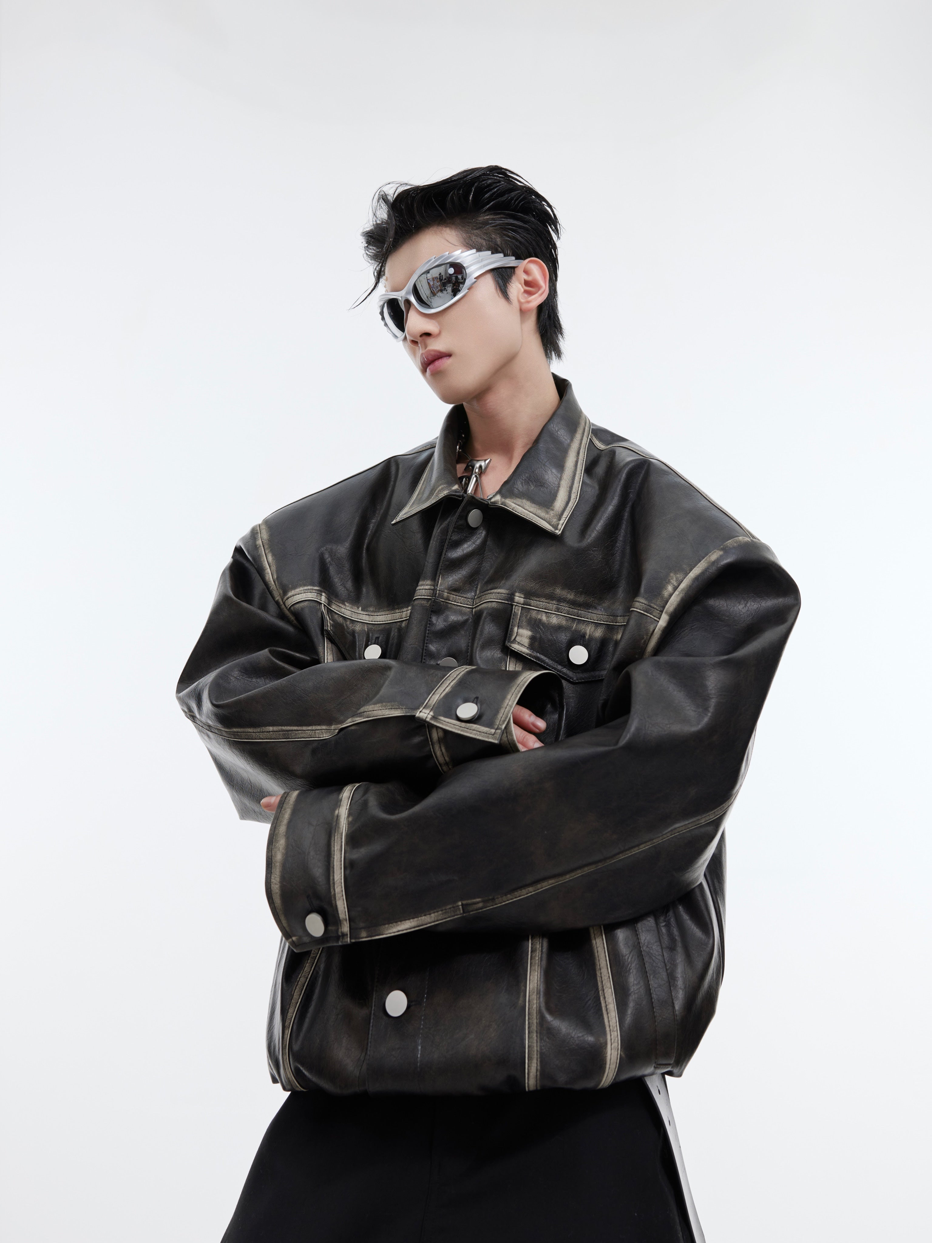 Vintage distressed leather jacket with avant-garde deconstructed panels and metal hardware accents, cropped biker style