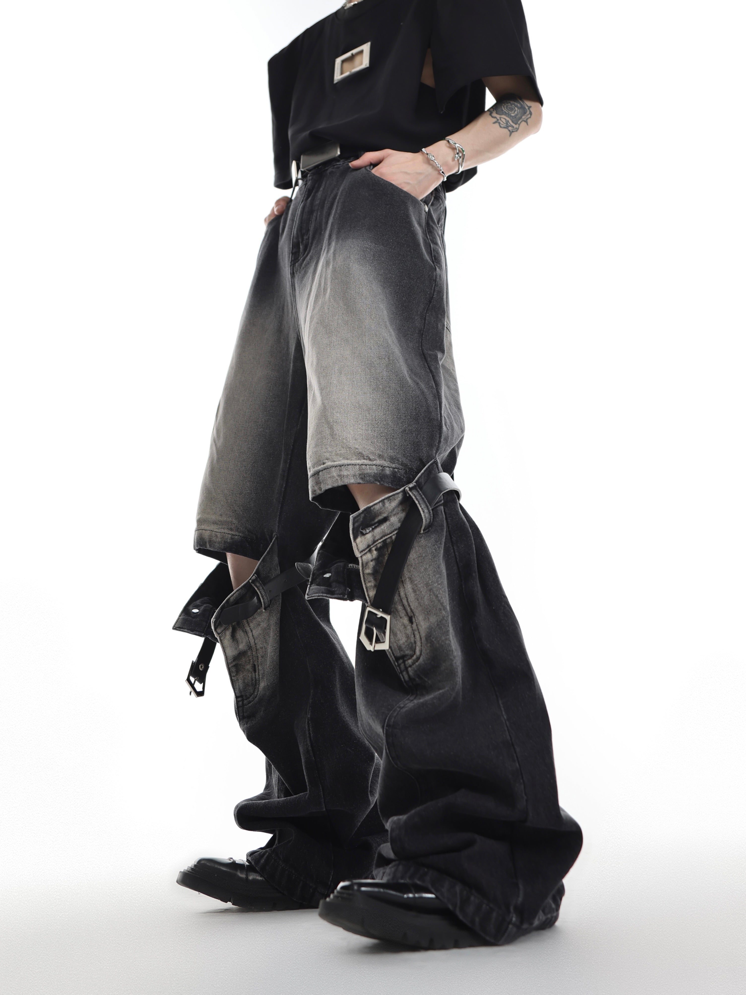 Vintage faded black flare jeans with high waist belt loop design, featuring distressed cut-out details for edgy streetwear look