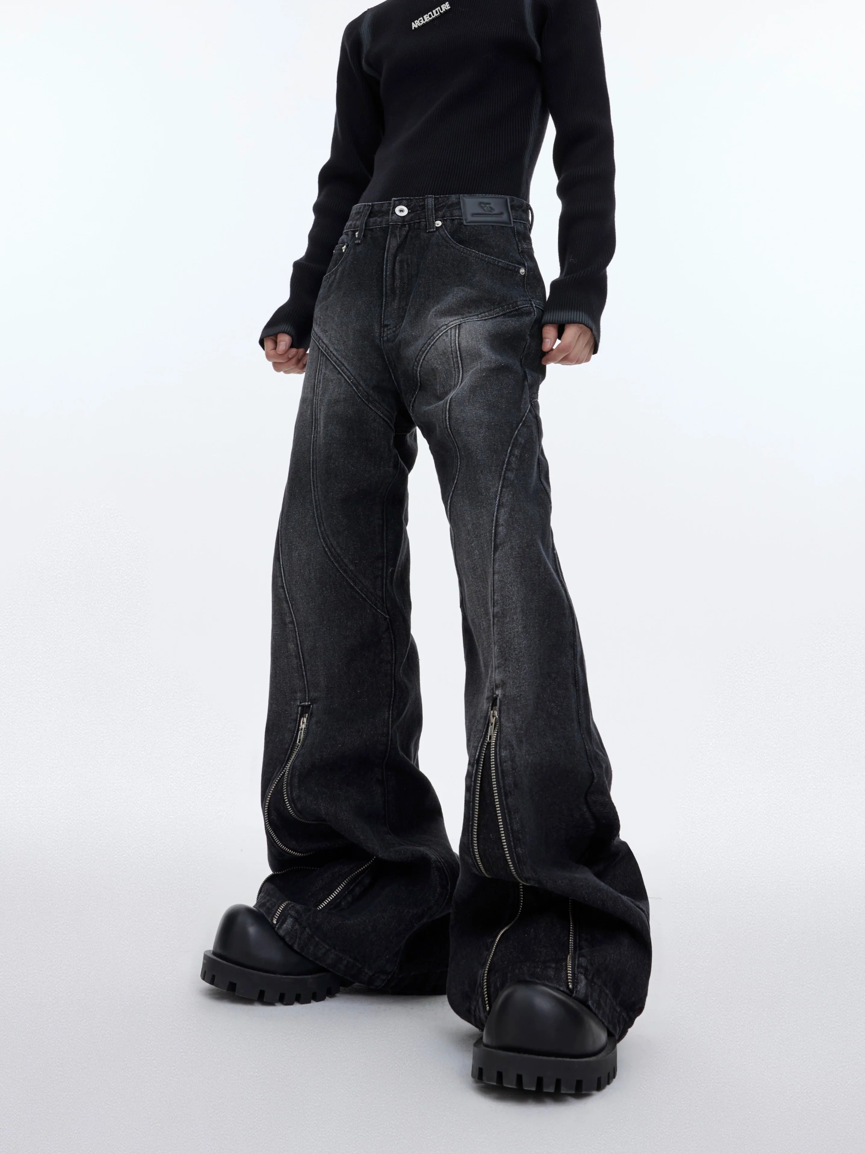 Vintage washed distressed flared jeans with bold metal zipper detailing, showcasing unique paint splatter effects for streetwear style