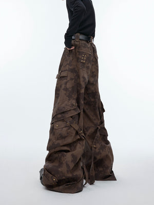 Close-up of metal button details on vintage washed cargo leather pants with distressed wide-leg design