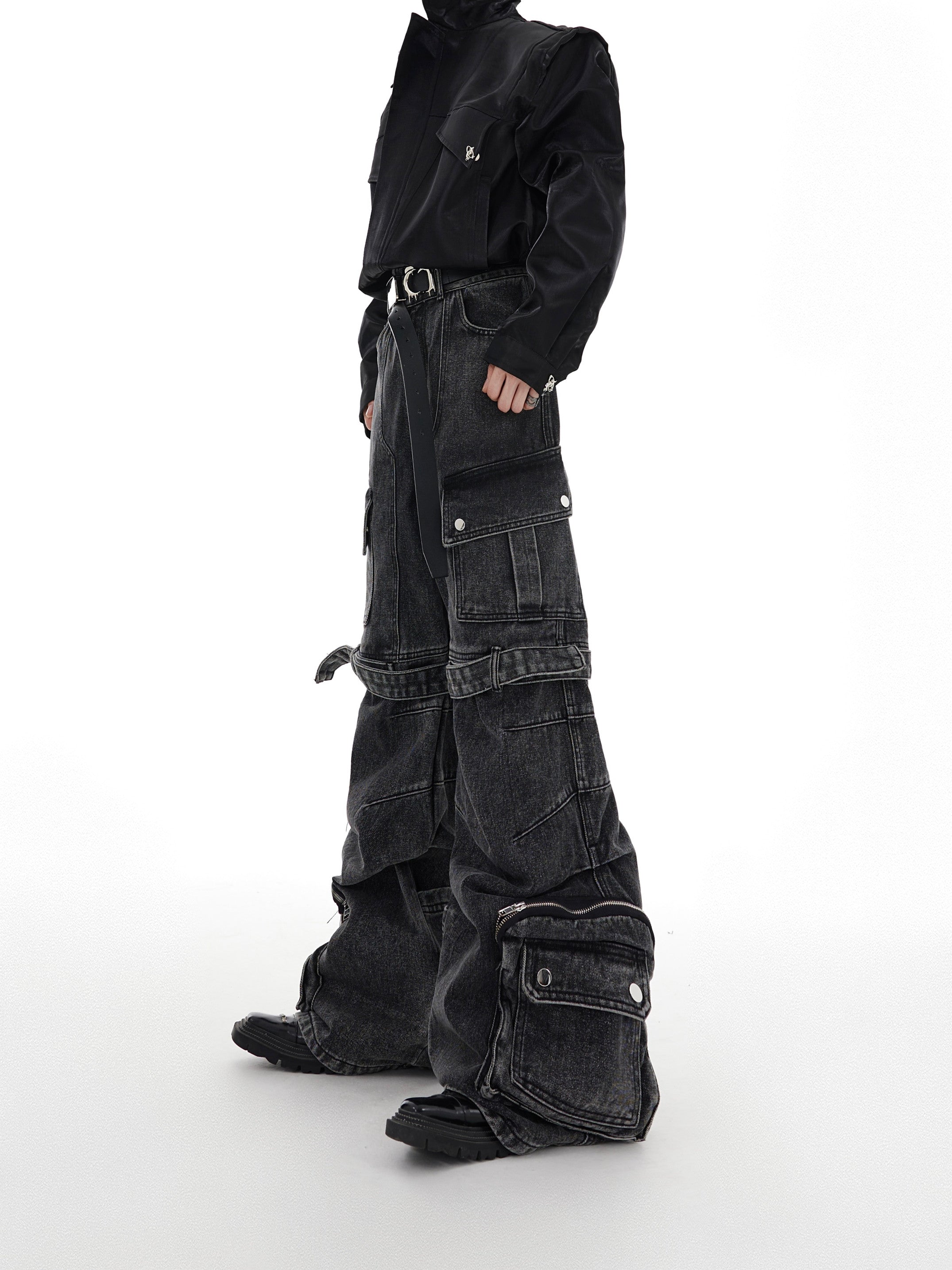 Front view of deconstructed washed denim cargo pants with signature strap detailing and multiple pockets