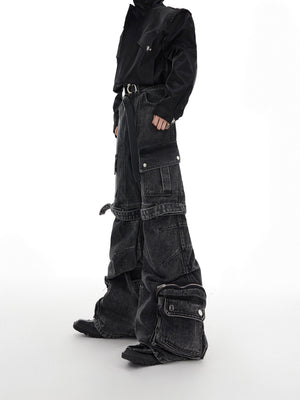 Front view of deconstructed washed denim cargo pants with signature strap detailing and multiple pockets