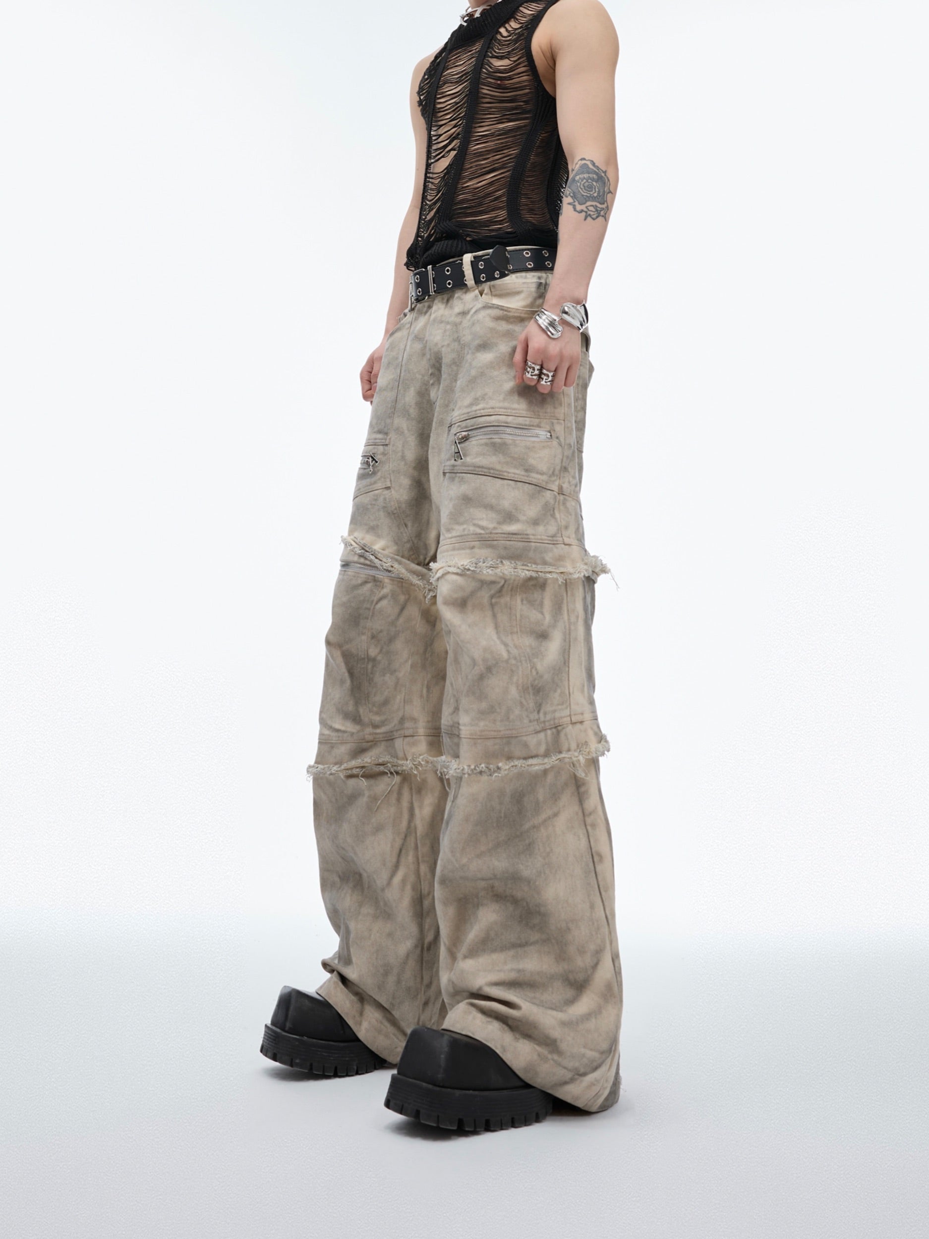 Back view of limited edition distressed jeans with dirty wash treatment and streetwear aesthetic