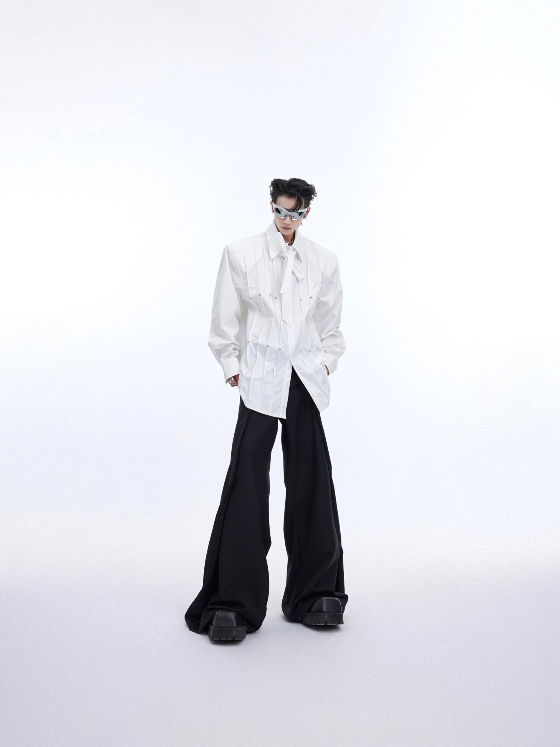 Close-up of structured shoulder pads on deconstructed oversized shirt with urban edge style