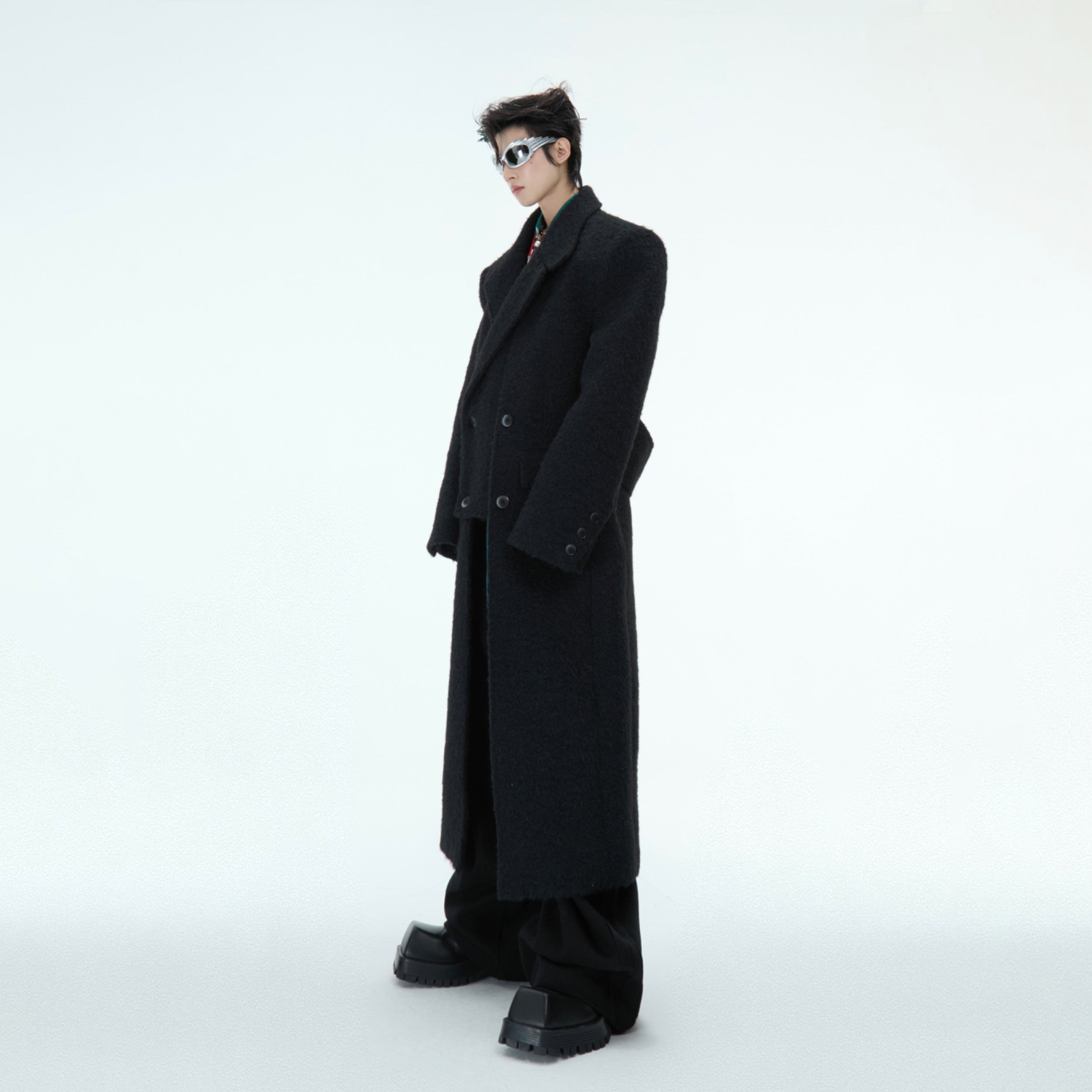 Close-up of the cinched waist detail on this oversized wool coat, highlighting the tailored yet edgy streetwear aesthetic